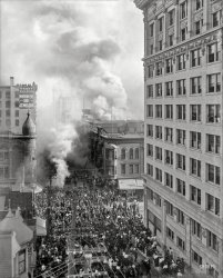 Nov. 15, 1908. "Los Angeles Pacific Railroad fire, Fourth Street between Hill and Broadway." 8x10 glass negative, photographer unknown. View full size.


Los Angeles Express, Nov. 16, 1908:

FIRE DESTROYS L.A.P. BUILDING

&nbsp; &nbsp; &nbsp; &nbsp; Flames broke out in the basement of the Los Angeles Pacific building at 314 W. Fourth St., adjoining the Broadway Department Store, at 2 o’clock yesterday afternoon and threatened serious loss.

&nbsp; &nbsp; &nbsp; &nbsp; The fire is believed to have had its origin in the rear of the basement, under the Sunset Bakery, at 320 W. 4th Street.

&nbsp; &nbsp; &nbsp; &nbsp; Fourth Street from Broadway to Hill was speedily roped off to keep the crowds back, and Broadway became a mass of humanity within a few minutes. Great volumes of smoke could be seen rolling up over the Broadway Department Store, creating the impression that it was that great store which was burning.

&nbsp; &nbsp; &nbsp; &nbsp; So quickly did the flames spread in the lower portions of the Los Angeles Pacific Building that the clerks and stenographers of the railway company in the offices on the second floor could not reach safety by the stairway or elevator. Fifteen girls and women were taken from the windows of the second floor with ladders.

&nbsp; &nbsp; &nbsp; &nbsp; The clouds of smoke that rolled from the building did not begin to compare in size with the cloud of spectators which sought to reach the scene of the fire.
