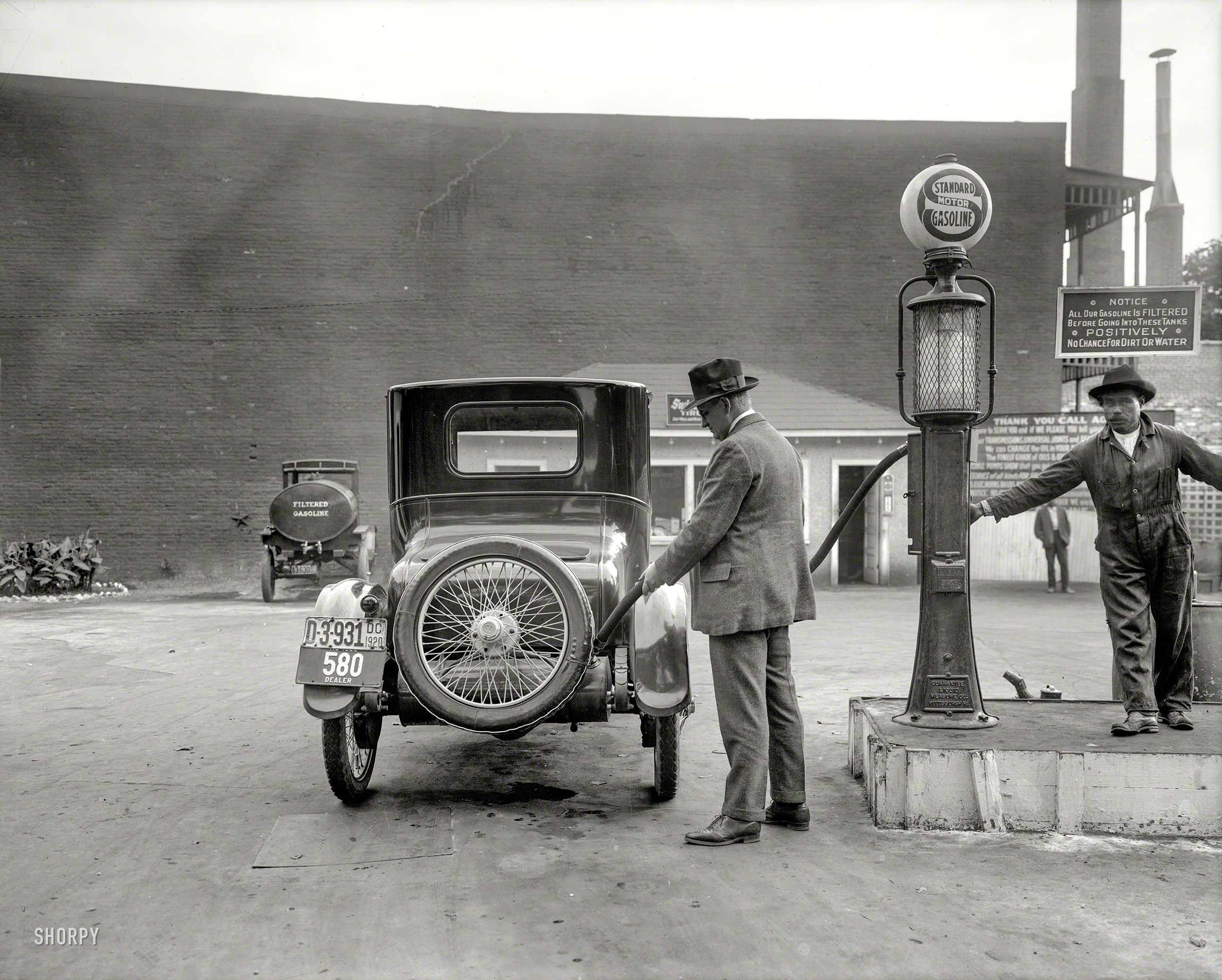 Washington, D.C., 1920. "Nation's Business." Back at the filling station seen here yesterday. 8x10 inch glass negative by Harris & Ewing. View full size.