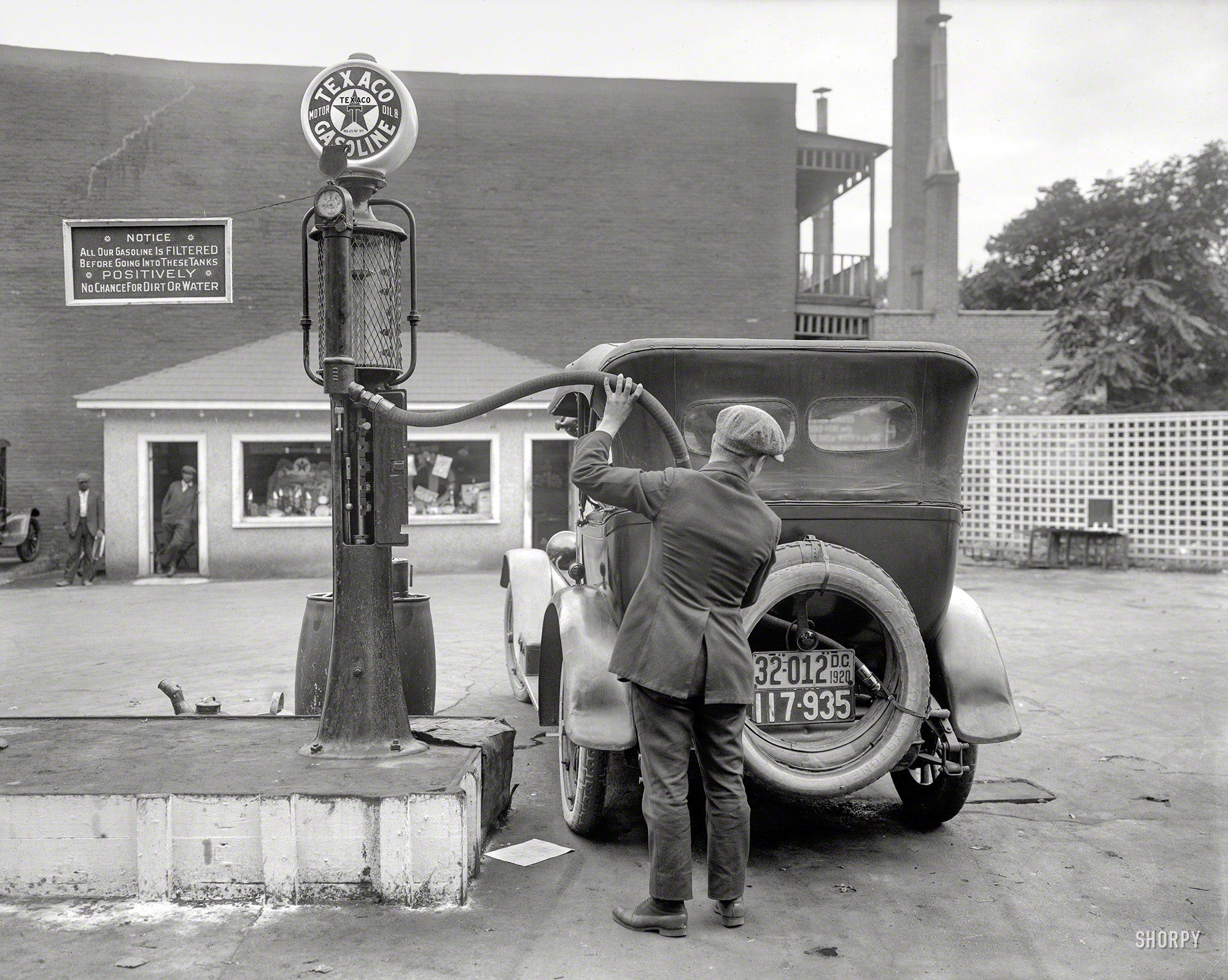 Washington, D.C., 1920. "Nation's Business." A photo made by Harris & Ewing for that magazine, giving an unusually detailed look at the gas station (and gas pump) of a century ago. 8x10 inch glass negative. View full size.