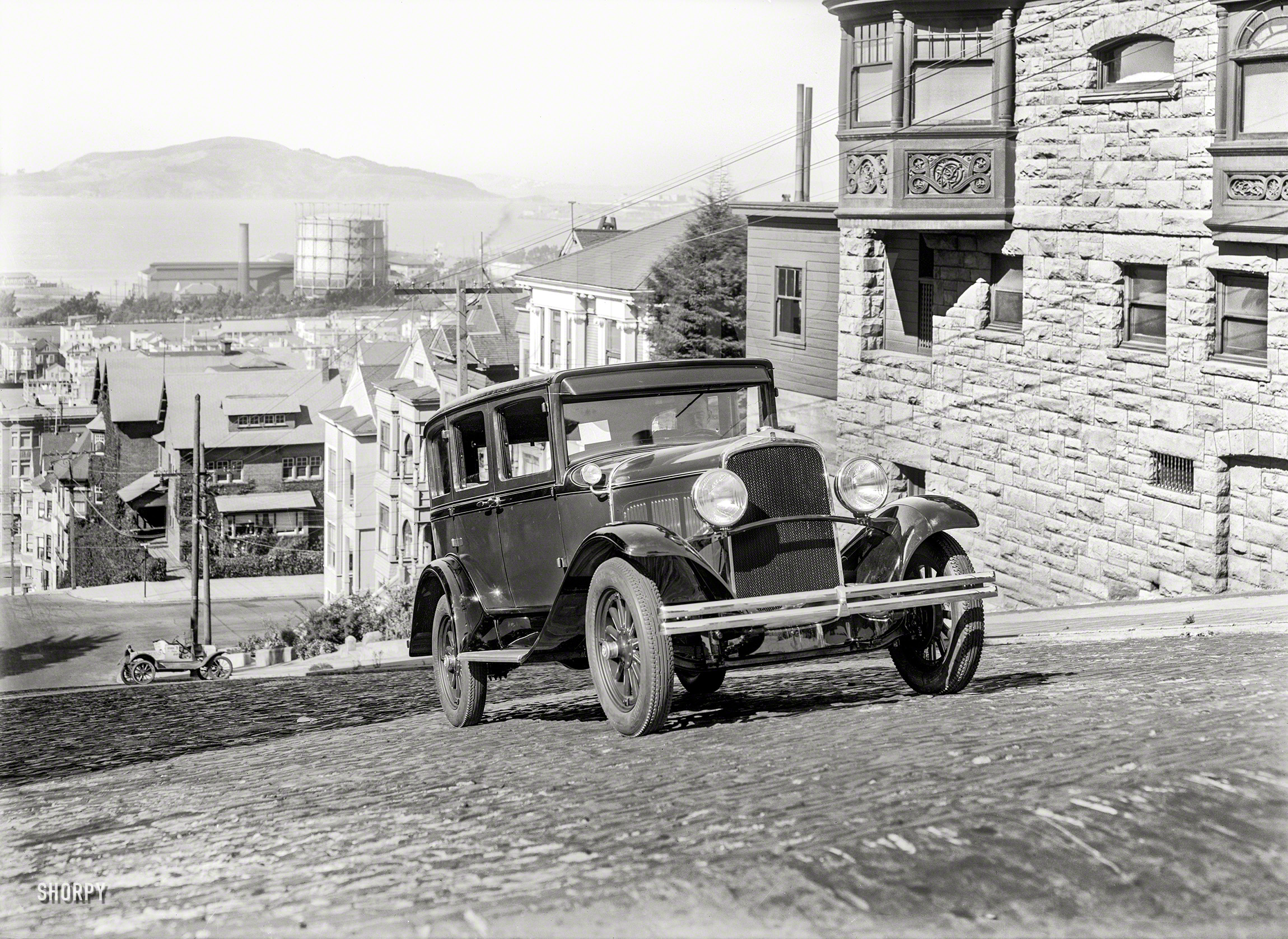 San Francisco circa 1928. "DeSoto sedan." Continuing our recent theme of cars-going-uphill, an early example of the marque passing a building we've seen here and here. 5x7 glass negative by Christopher Helin. View full size.