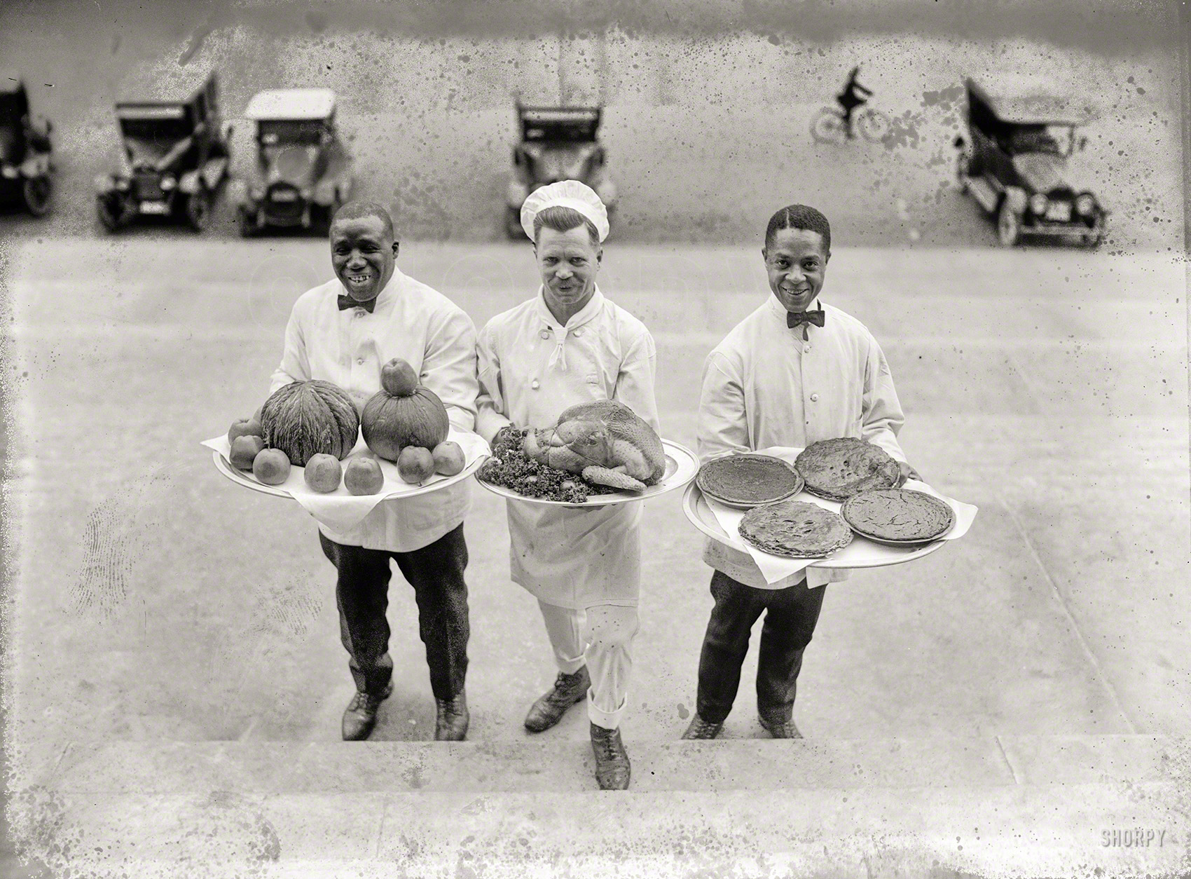 December 27, 1922. Washington, D.C. "Cooks with turkey, pies, and apples on platters." National Photo Company Collection glass negative. View full size.