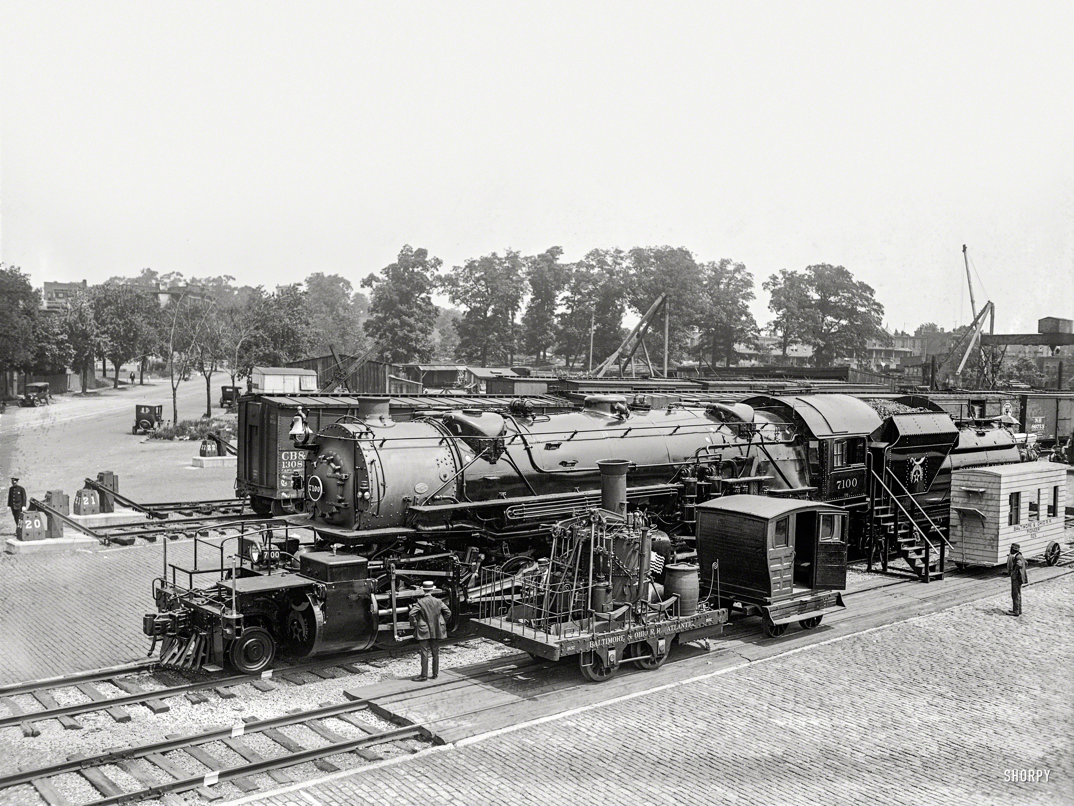 "Past and present in locomotives. Eckington Yards, June 4, 1923." A closeup of the locomotive seen here yesterday in the Baltimore & Ohio rail yard during the Masonic convention in Washington, D.C. The big engine wears the livery of "Boumi Temple," a Baltimore Shrine lodge. 5x7 glass negative.  View full size.