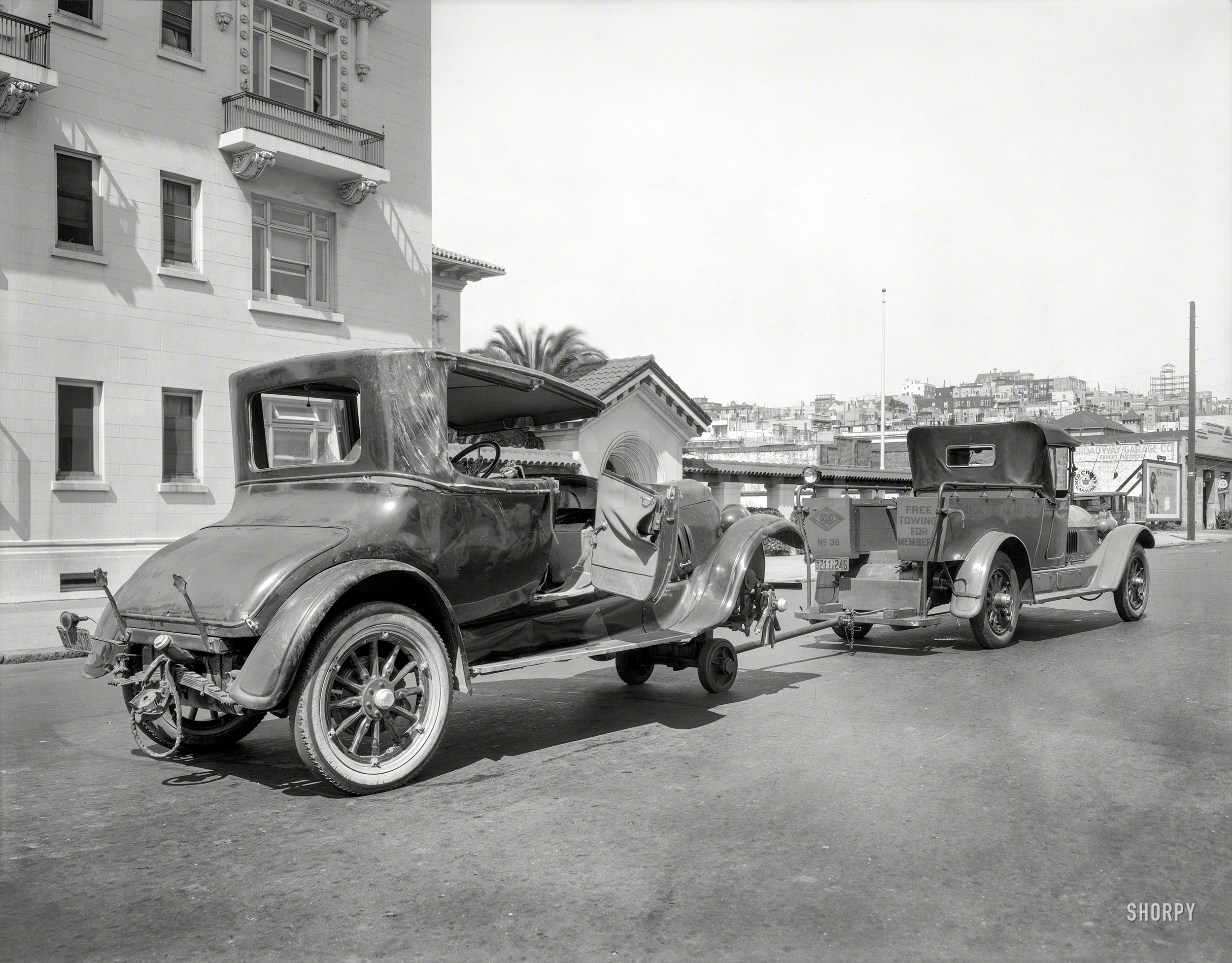 San Francisco, 1925. "California State Automobile Association. Wrecked Peerless being hauled at hospital on Broadway between Van Ness & Polk." 8x10 film negative, originally from the Wyland Stanley collection. View full size.