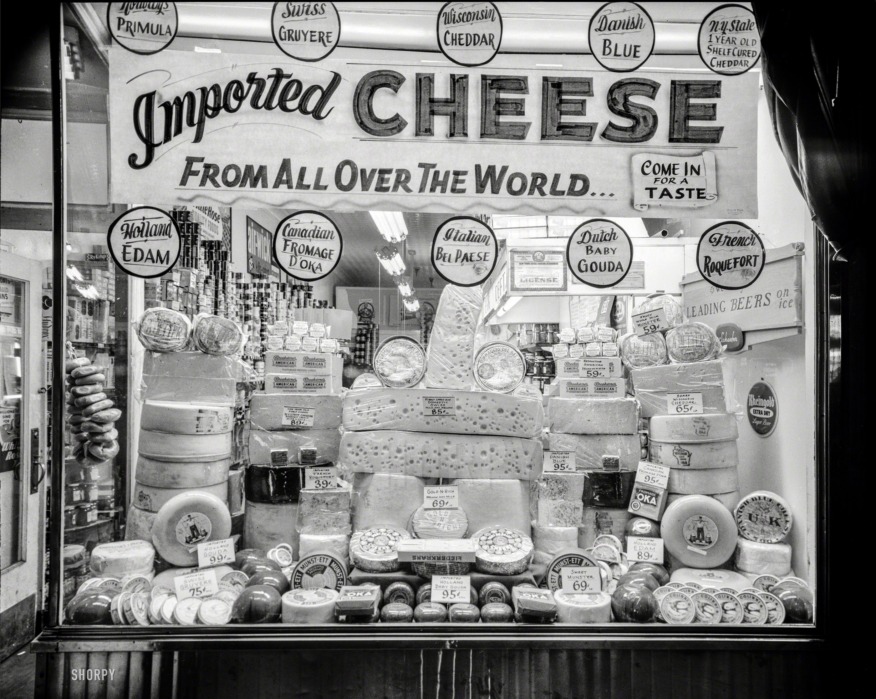 New York circa 1948. "Window display of imported and domestic cheeses." Everything looks so ... gouda. 4x5 negative by John M. Fox. View full size.