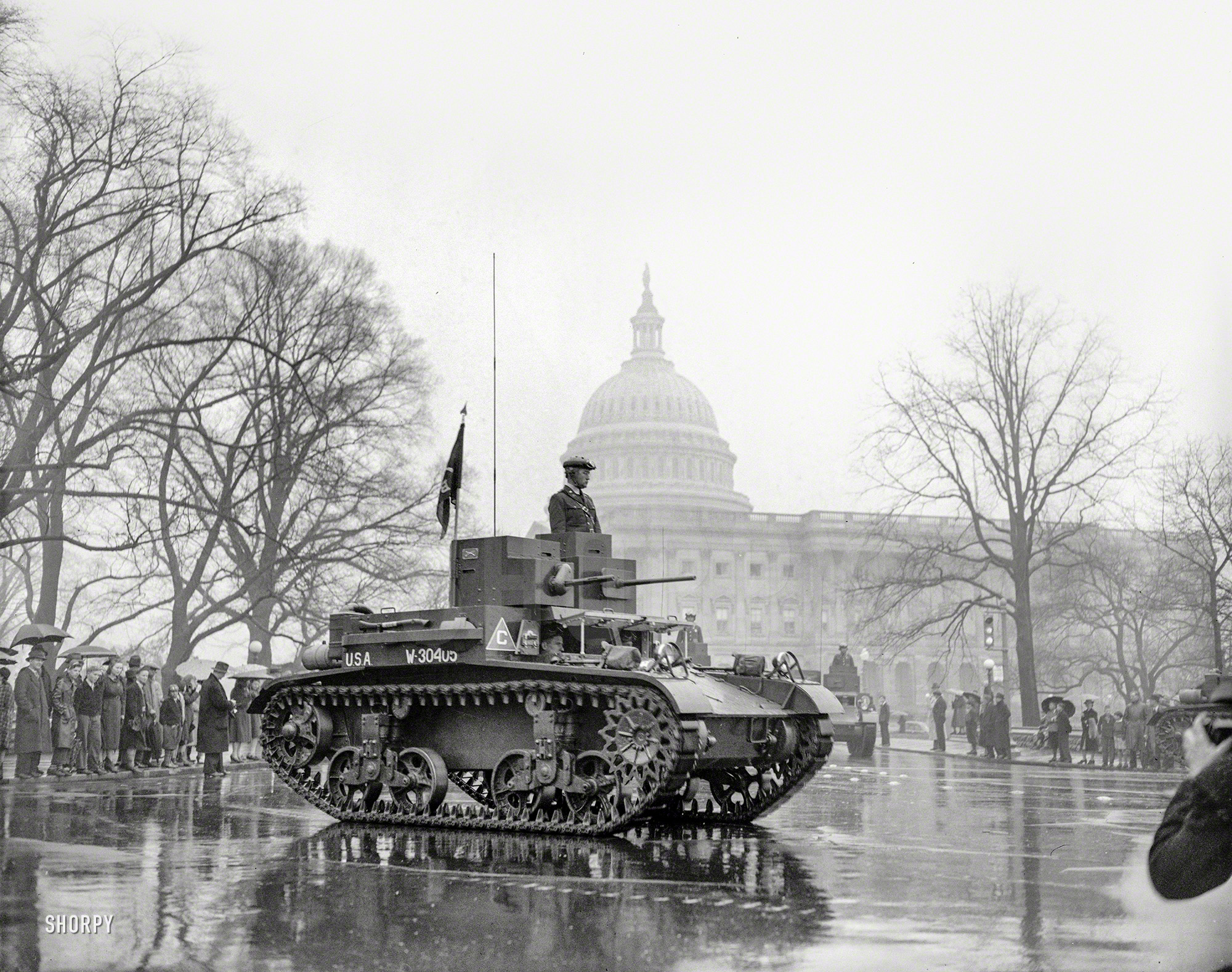 April 6, 1939. "Memories of the World War were revived today as the latest types of tanks, preceded by 20,000 soldiers and veterans, paraded past the U.S. Capitol in the annual Army Day Parade which marked the 22nd anniversary of America into the World War. Thousands braved a heavy downpour to view the parade." Harris & Ewing Collection glass negative. View full size.
