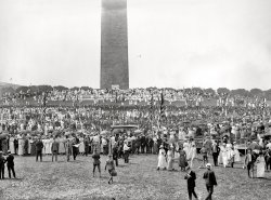 July 4, 1919. "Washington's men and women who served during the war gathered at the base of the Washington Monument, receiving medals of honor provided by the citizens of the District of Columbia. The big crowd has just turned to watch a daring aviator circling low above the trees that surround the monument grounds." National Photo glass negative. View full size.
