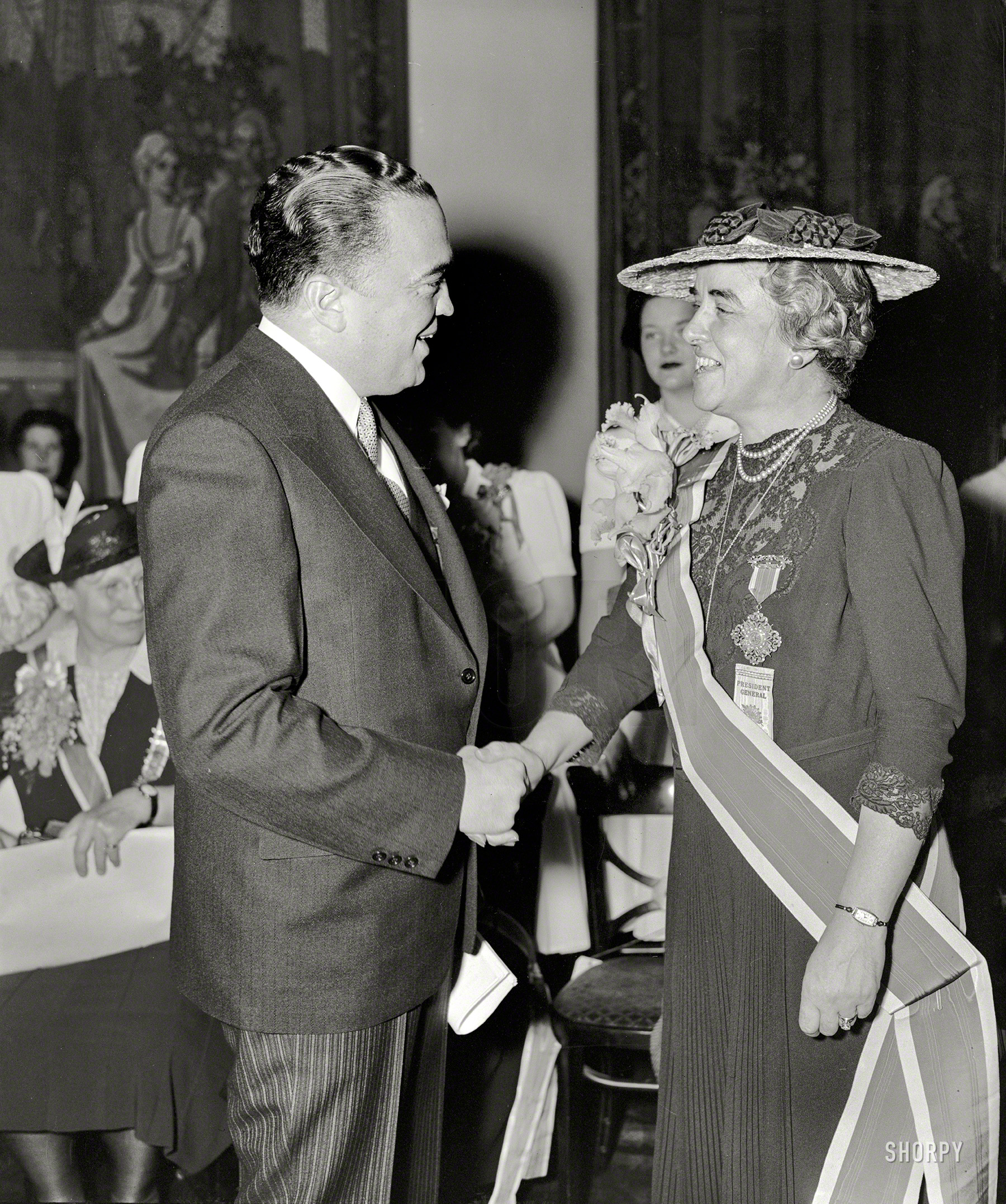 Washington, D.C., 1940. "Daughters of the American Revolution reception. J. Edgar Hoover, Federal Bureau of Investigation director, greets Mrs. Henry M. Robert Jr., President General of the D.A.R." View full size.
