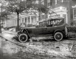 January 1921. Washington, D.C. "Penrose car, accident." Senator Boies Penrose's Winton Six touring car, last seen here,  after taking out a mailbox, call box and lamppost on an icy sidewalk. National Photo Company Collection glass negative. View full size.