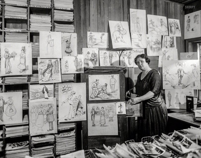 &nbsp; &nbsp; &nbsp; &nbsp; "Suffrage Headquarters -- Historian Helena H. Woods visits the office of cartoonist Nina E. Allender to view pictures and images."
Washington, D.C. "Suffrage art, January 29, 1921." A few months after passage of the 19th Amendment gave American women the right to vote. National Photo Company Collection glass negative. View full size.
