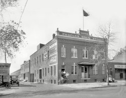 Washington, D.C., circa 1921. "Warehouse, People's Drug Store." Next door to the Knights of Columbus Evening School Garage in what seems to be the auto-repair district. National Photo Company Collection glass negative. View full size.