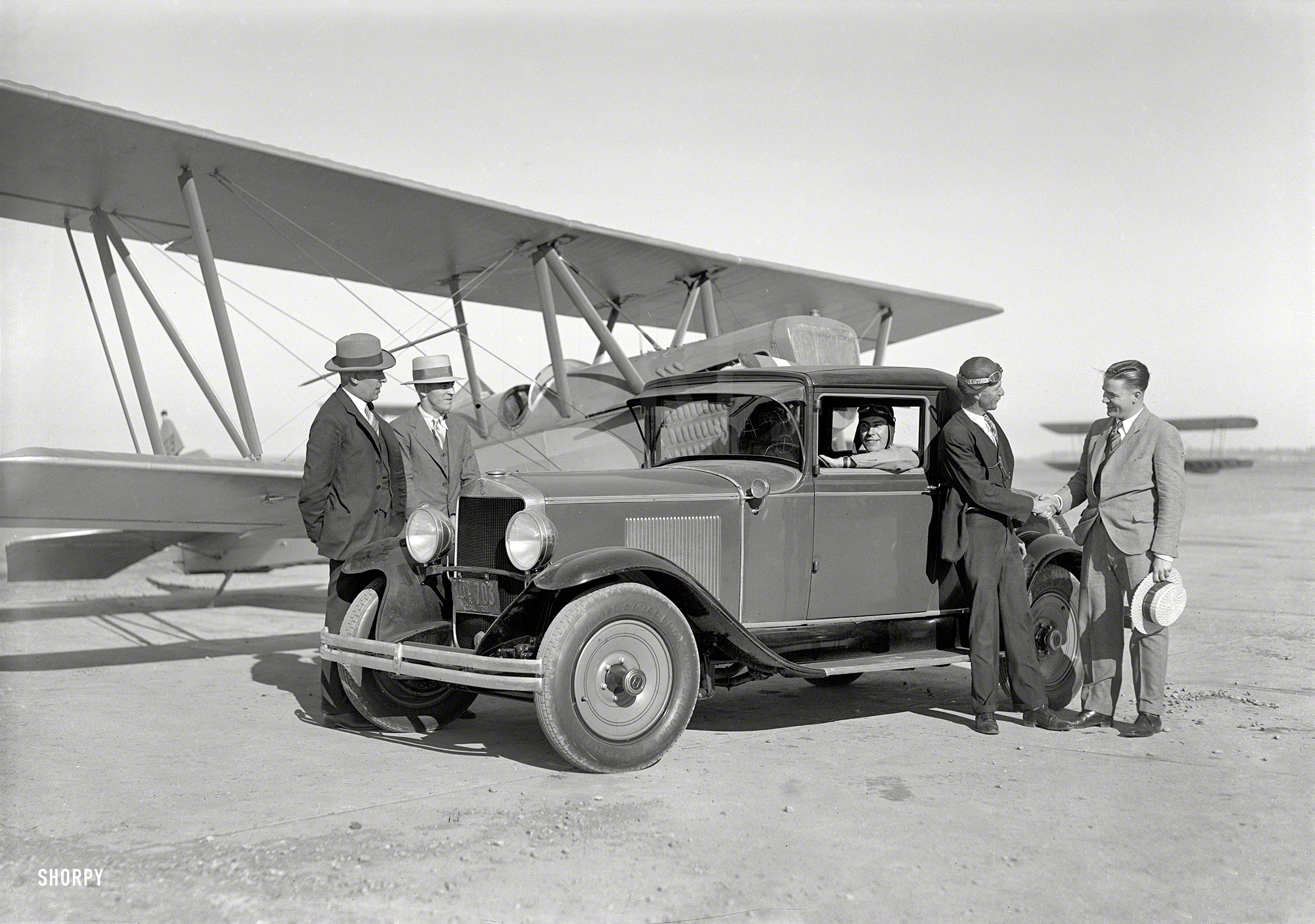 San Francisco, 1929. "Paige coupe and biplane at Mills Field." Latest entry in the Shorpy Catalog of Quaint Conveyances. 5x7 glass negative. View full size.