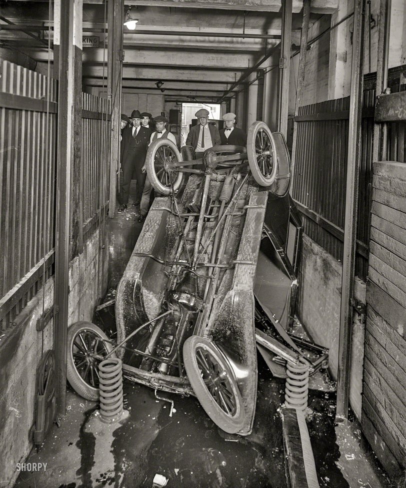 Washington, D.C., circa 1920. "Garage elevator wreck." Coming back up will be trickier, if less spectacular.  National Photo Co. glass negative. View full size.
