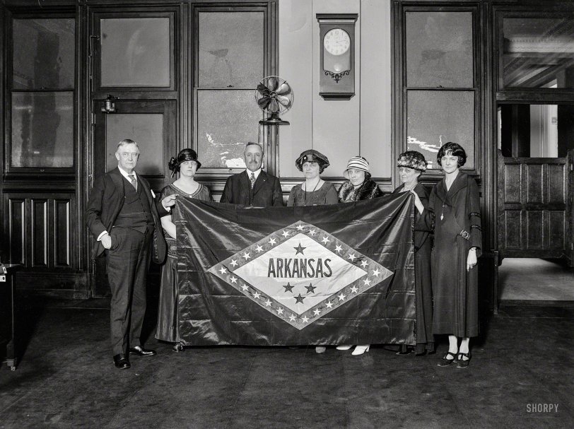 April 1924. Washington, D.C. "Group holding Arkansas state flag." Regnat populus! Harris &amp; Ewing Collection glass negative. View full size.
