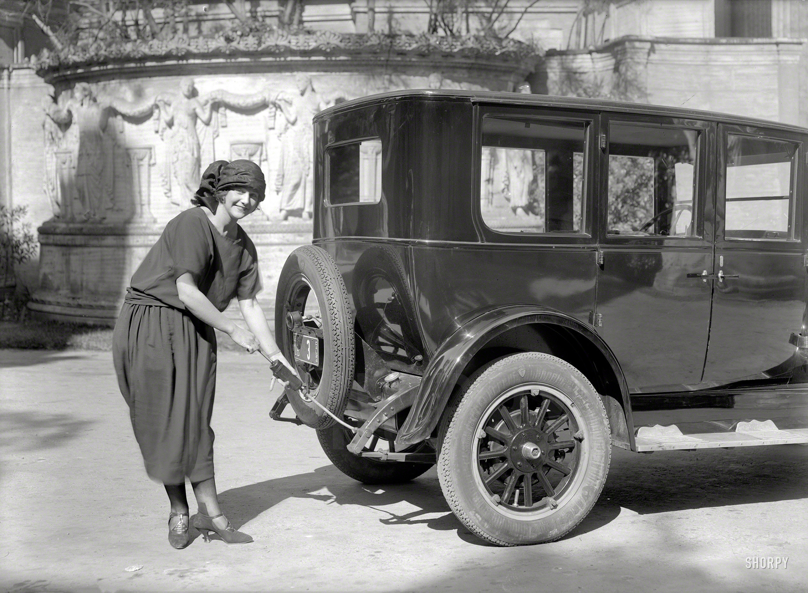 San Francisco, 1924. "Lady greasing Oldsmobile sedan." A pioneer of Women's Lubrication. 5x7 glass negative by Christopher Helin. View full size.