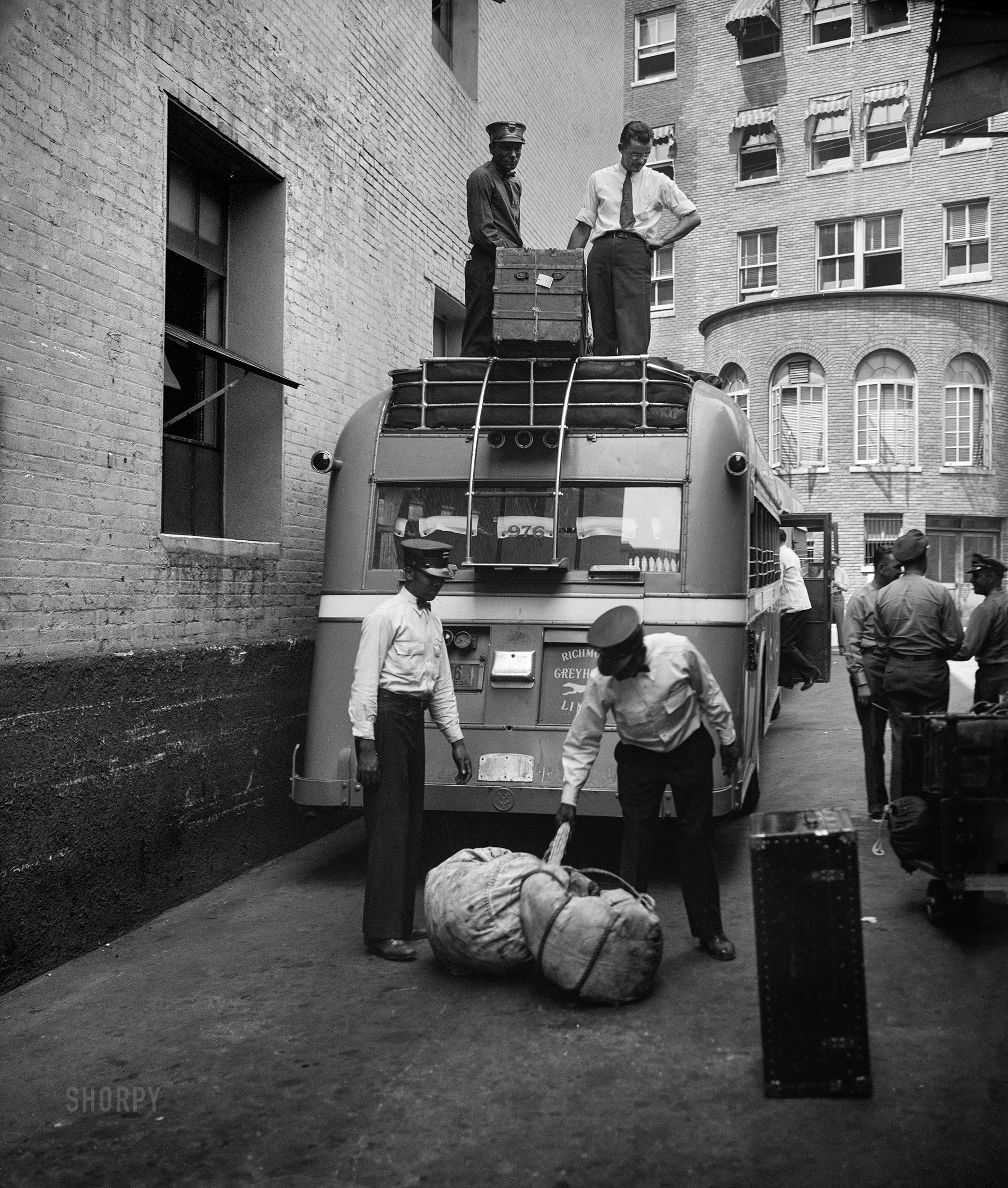 Washington, D.C., 1936. "Bus transportation -- loading baggage on motor coach." 4x5 inch glass negative, Harris & Ewing Collection. View full size.