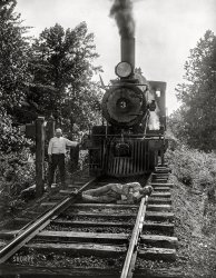 June or July 1926. Washington, D.C., or vicinity. "NO CAPTION [Man lying in front of train on tracks]." Perhaps some diligent Shorpysleuth can figure out what's going on here. 4x5 inch glass negative, Harris & Ewing Collection. View full size.