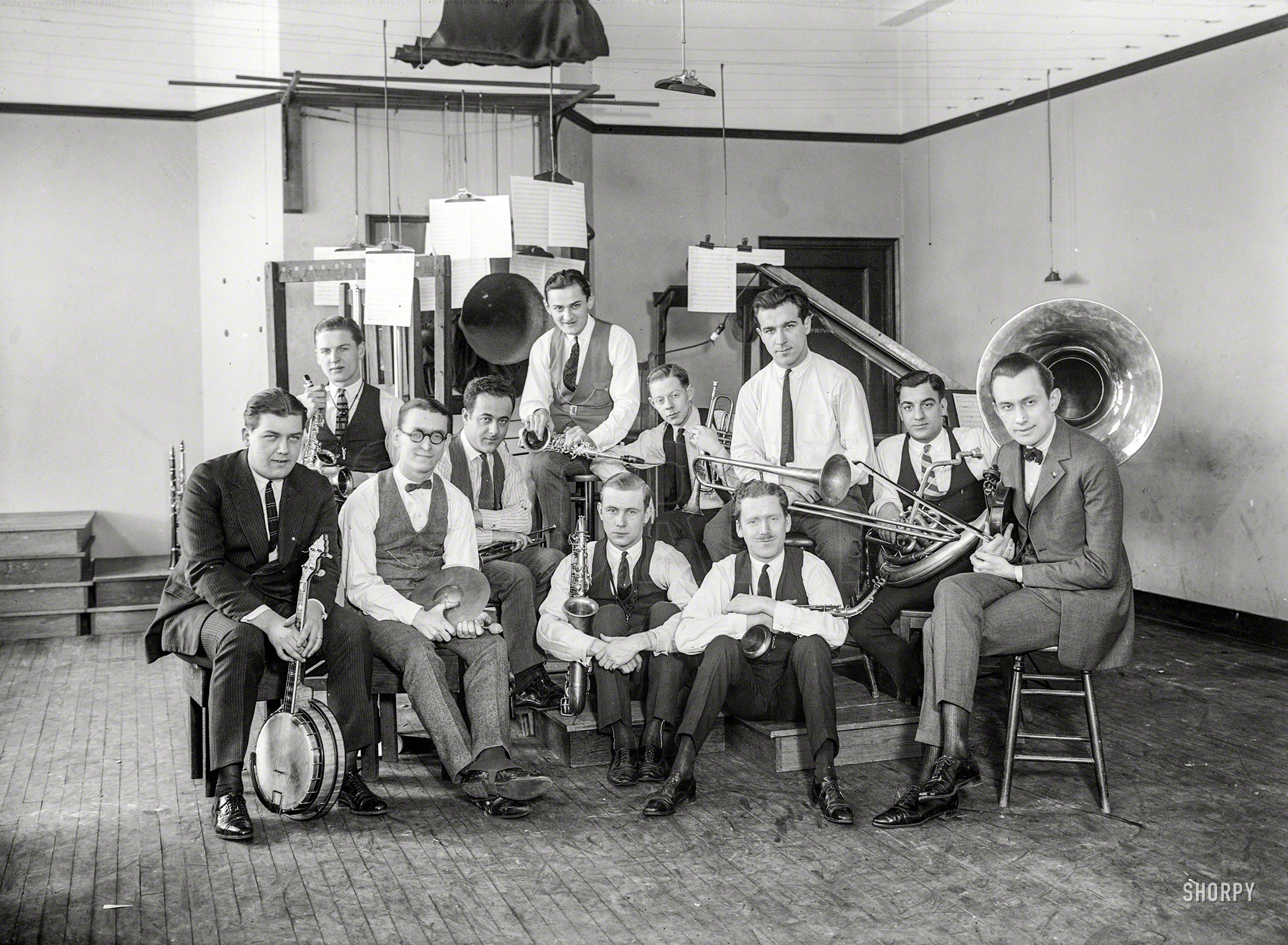 New York circa 1922. "Paul Specht band." Last seen at the Astor Roof Garden, and now in the recording studio also seen here. Note arrangement of the scores around the acoustic recording horn. 5x7 glass negative. View full size.