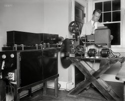 &nbsp; &nbsp; &nbsp; &nbsp; UPDATE: "Pioneer television inventor (Dr. C. Francis Jenkins, not pictured) opens new radio movie broadcasting station. Laboratory assistant Paul Thomsen examining machine made to broadcast motion pictures by radio." More photos here.
Washington, D.C. July or August 1929. "NO CAPTION" is all it says on this Harris & Ewing glass negative with an audiovisual vibe. Who can help us fill in the blanks?  View full size.