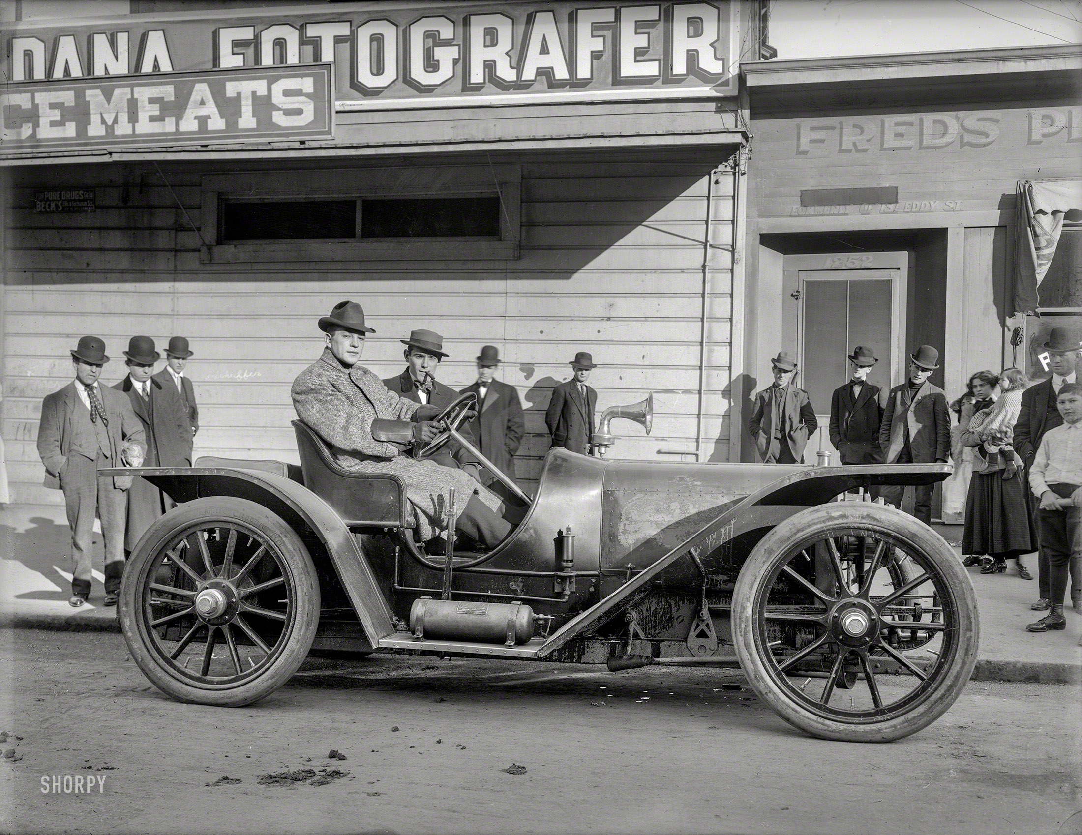 San Francisco, 1908. "Boxer Stanley Ketchel at wheel of American Underslung auto with manager Britt Willis." Both of whom would be dead not long after this photo was made -- middleweight champion Ketchel (the "Michigan Assasssin") fatally shot in a training-camp robbery in 1910, and Willis the victim of a "violent stomach hemorrhage" in 1909. Their car, an American Underslung, was among the first to employ the now-universal dropped frame, with the bottom of the car below the axles. 6½ x 8½ glass negative by Dana Studio, from the collection of George Whitney Jr. (1922-2002), owner of the Cliff House restaurant. View full size.