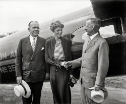 &nbsp; &nbsp; &nbsp; &nbsp; Washington, D.C., June 22 -- A slim young aviatrix with wayward locks, Amelia Earhart Putnam, first woman to make a solo flight across the Atlantic, received a supreme award for courage and achievement last night when President Hoover presented her with the first gold medal of the National Geographic Society ever awarded to a woman.
June 1932. Washington, D.C. "Aviator Amelia Earhart Putnam being greeted by Drs. Gilbert Grosvenor, right, and John Oliver la Gorce of the National Geographic Society." Harris & Ewing Collection glass negative. View full size.