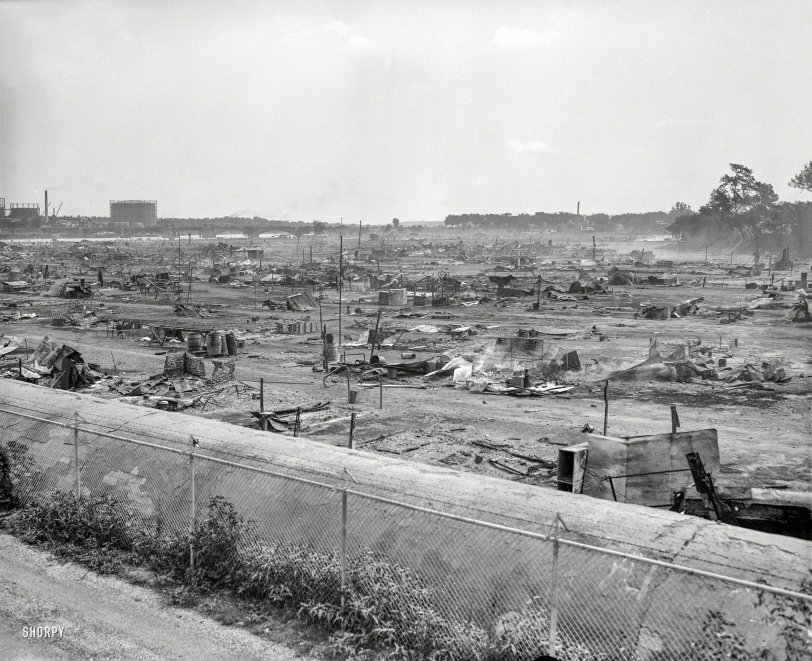 Washington, D.C., 1932. "Vacated 'Bonus Army' camp." Burned-out remnants of the Bonus marchers' camp in Anacostia Flats, with gas holders and what looks like a railroad bridge in the distance. And in the foreground, what we suppose might be conduit for the D.C. aqueduct. Harris &amp; Ewing glass negative. View full size.
