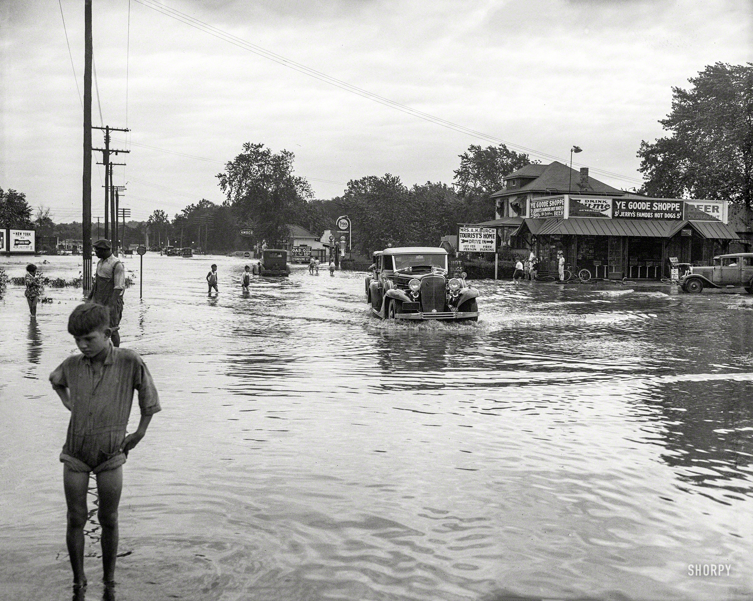 Washington, D.C., or vicinity. "Flooding." Aftermath of the "Chesapeake-Potomac" hurricane of August 1933, which led to the train wreck seen here a few days ago. Who can locate this water-logged crossroads, with "Goode Shoppe" hot dogs going for a nickel? Harris & Ewing glass negative. View full size.