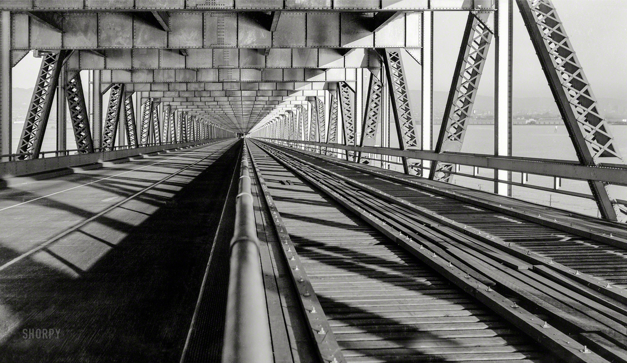 January 20, 1938. "San Francisco-Oakland Bay Bridge under construction. View of track and roadway, lower deck, East Bay. Caltrans, photographer." Historic American Buildings Survey, Library of Congress. View full size.