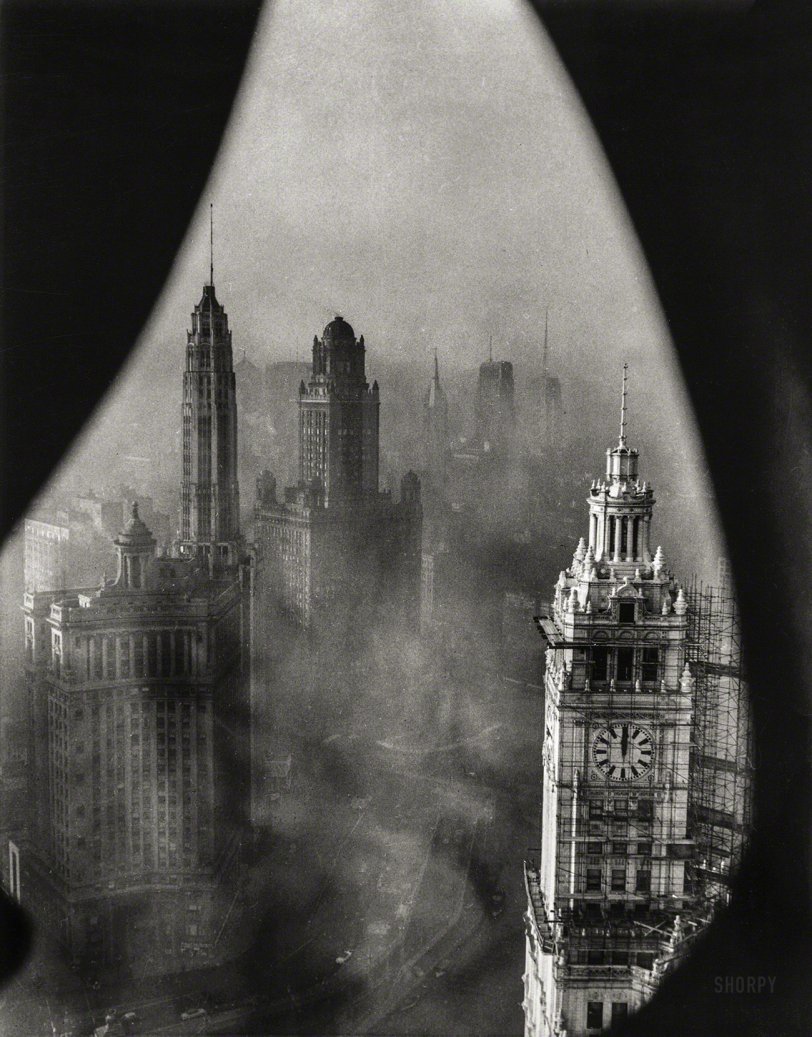 November 1, 1952. "Chicago framed by Gothic stonework high in the Tribune Tower. This view of Chicago's downtown shows the low-lying smog which blanketed the area one recent morning. In the foreground is the well-known Wrigley Building." Underwood &amp; Underwood photo. View full size.
