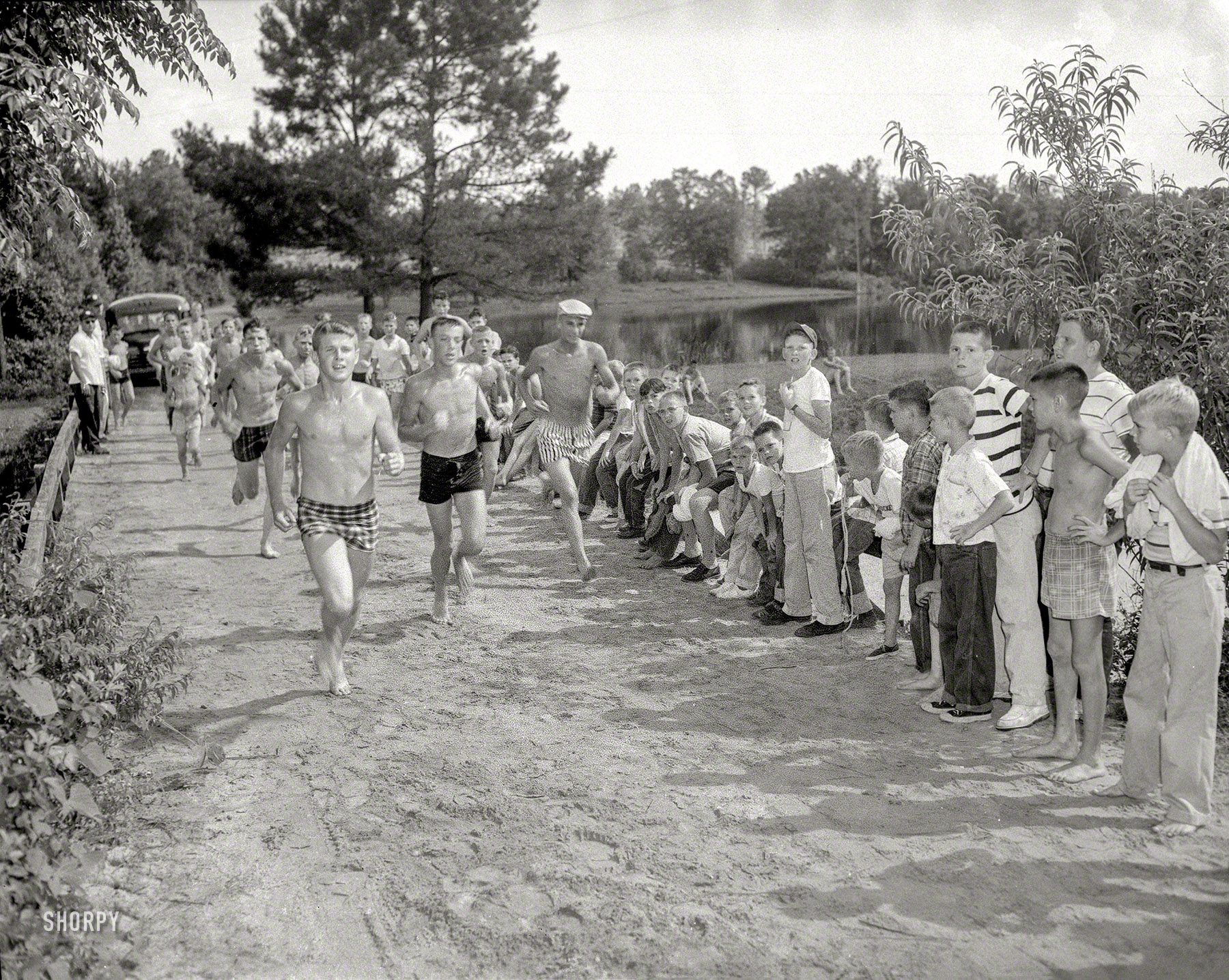Columbus, Georgia, circa 1959. "Swim camp. Boys at park." Making a break from the bus. 4x5 acetate negative from the News archive. View full size.