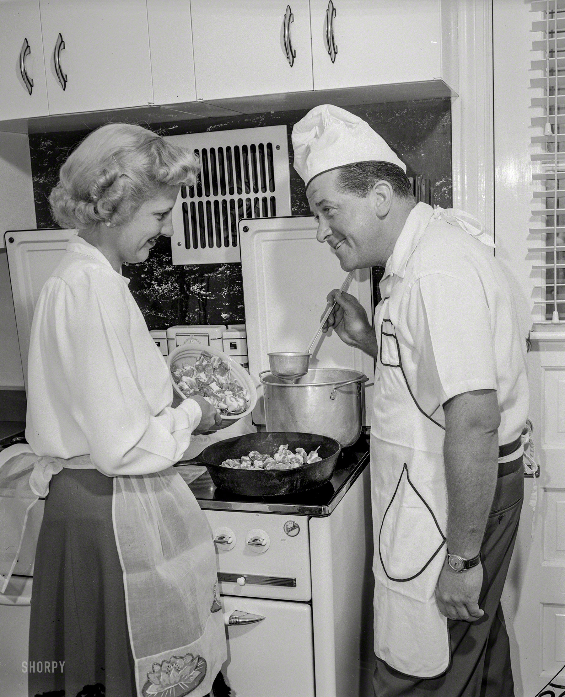 "Man and woman at stove cooking." The first of thousands of 4x5 negatives, retired from the archives of mid-century newspapers, acquired by Shorpy. Most of these are undated and have little or no caption information. If you recognize any of the subjects or locales, let us know in the Comments. View full size.
