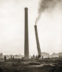Sept. 17, 1935. "These two 150-foot-tall brick smokestacks on the Mall in Washington, D.C., were considered an eyesore and ordered demolished. The closer stack fell shortly after the far one toppled. They were erected when a central heating plant occupied the site." Harris &amp; Ewing glass negative. View full size.
Holy smoke!Was there a fire in that far stack when they toppled it?
[My guess: dust being forced up the chimney by the force of its collapse? -tterrace]
Must have been in a hurryThey didn't even wait for it to stop smoking.
Physics in actionNote the crack forming 1/3 way up the falling stack.
An interesting fact of physics is that all debris from a non-monolithic falling structure will land within a distance 2/3 of its height.
It&#039;s probably smokeThey may have used fire to bring them down.
http://www.youtube.com/watch?v=0L1WOnR2KBY
(The Gallery, D.C., Harris + Ewing)