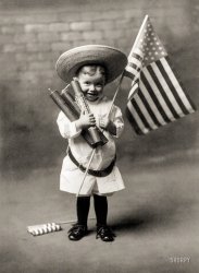 "Independence Day, 1906. F.A. Loumis, copyright claimant.  Little boy holding three large firecrackers and flag." Let's be careful out there! View full size.