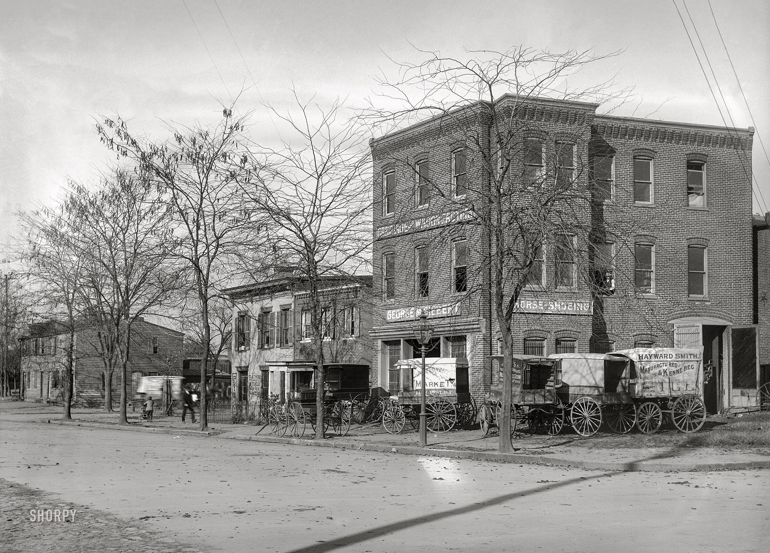 &nbsp; &nbsp; &nbsp; &nbsp; Back when you could leave your ice-wagon at the blacksmith's unlocked.
Washington, D.C., circa 1901. "View of E Street S.W. between Delaware Avenue & First Street, looking northwest." 5x7 inch glass negative, D.C. Street Survey Collection.  View full size.