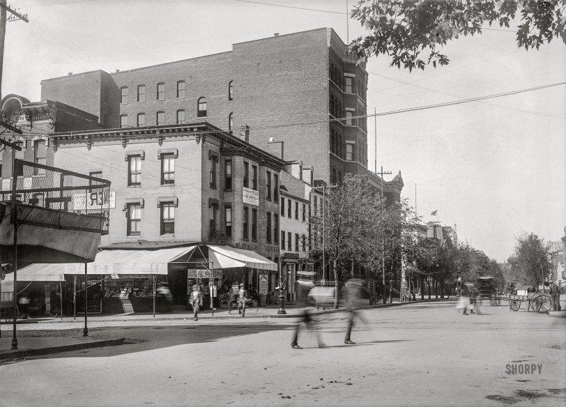 Washington, D.C., circa 1901. "View of E Street N.W., south side, looking west from Seventh Street towards Eighth." 5x7 inch glass negative, D.C. Street Survey Collection. View full size.
