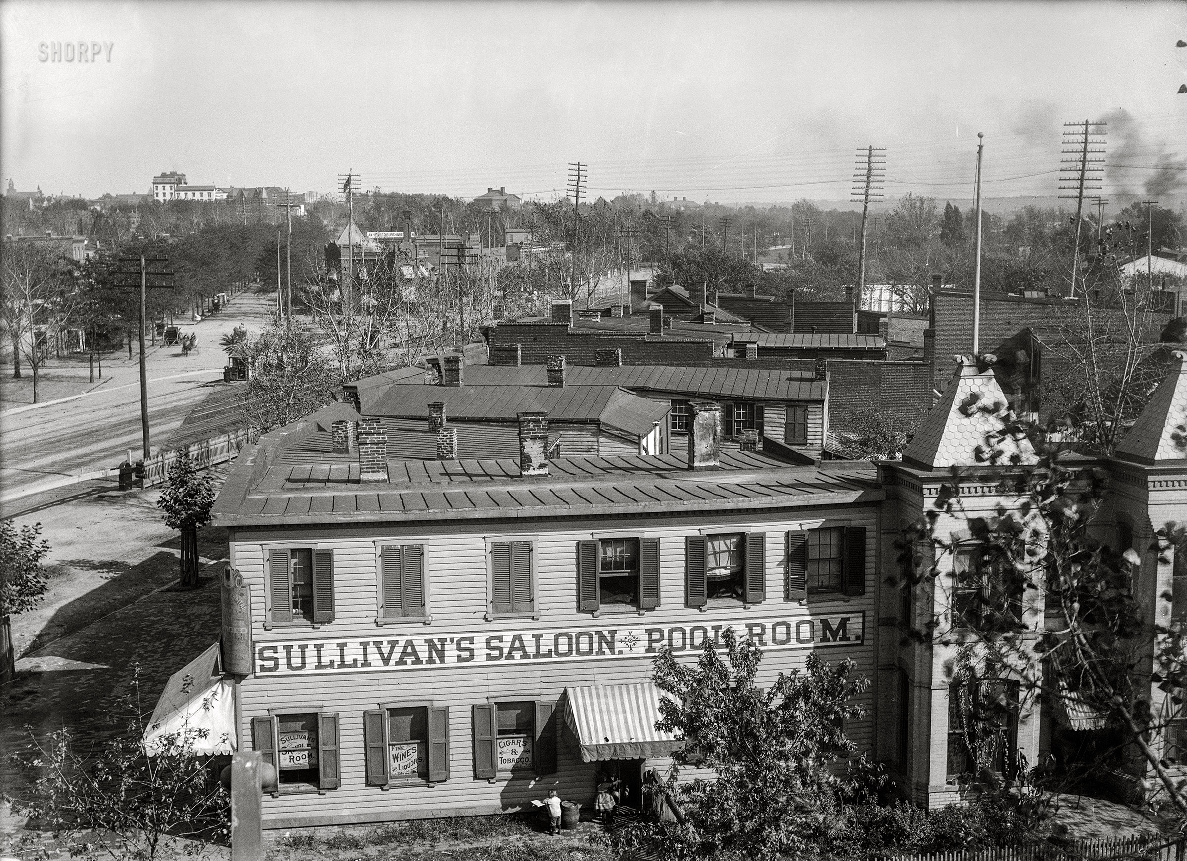 Washington, D.C., circa 1901. "Elevated view of Virginia Avenue S.W. at E Street, showing Sullivan's Saloon & Pool Room." 5x7 glass negative from the D.C. Street Survey. View full size.