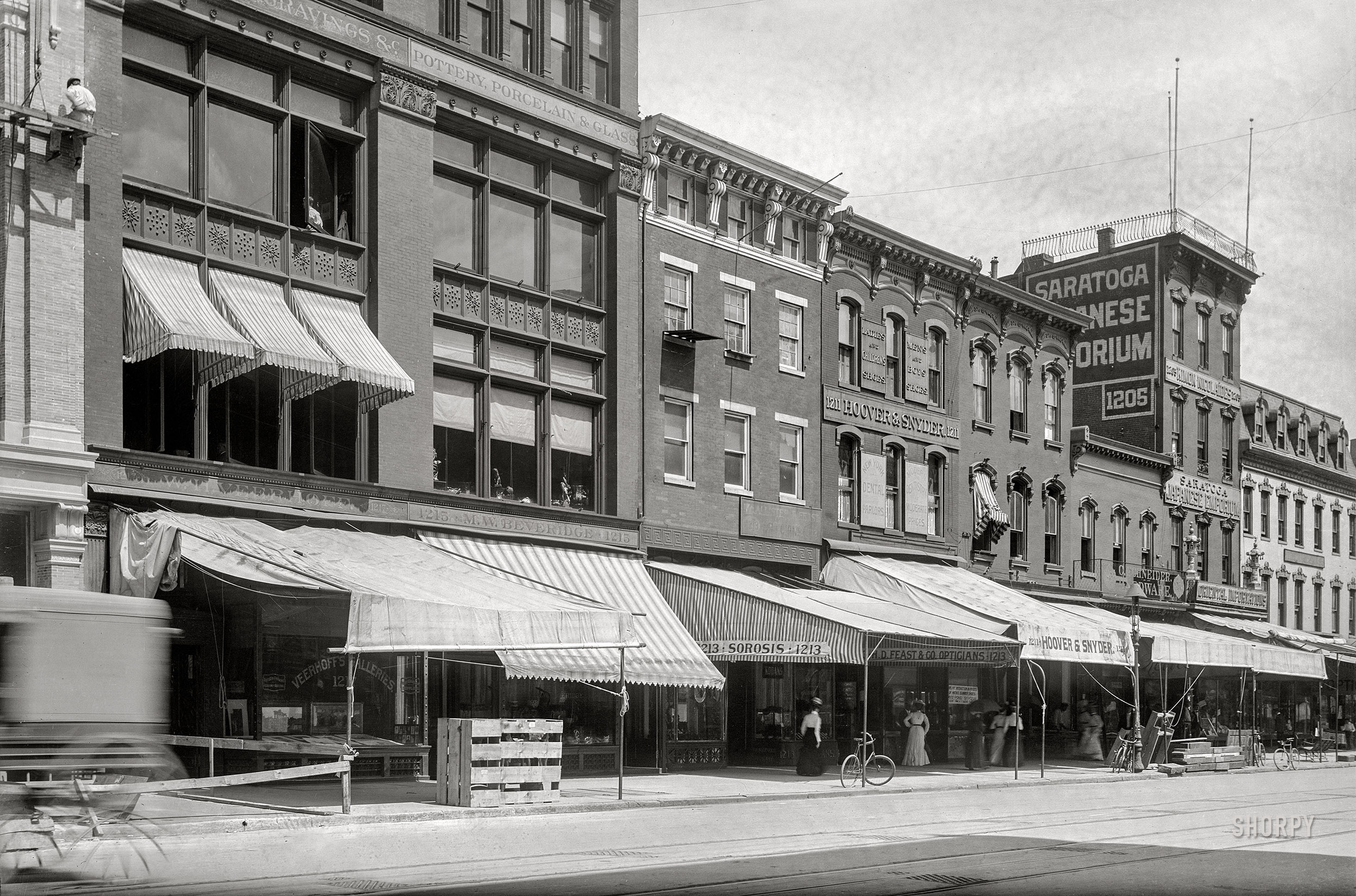 Washington, D.C., circa 1901. "Businesses on F Street N.W., north side, between 12th & 13th Streets, Nos. 1201-1219." 5x7 glass negative, D.C. Street Survey Collection.  View full size.