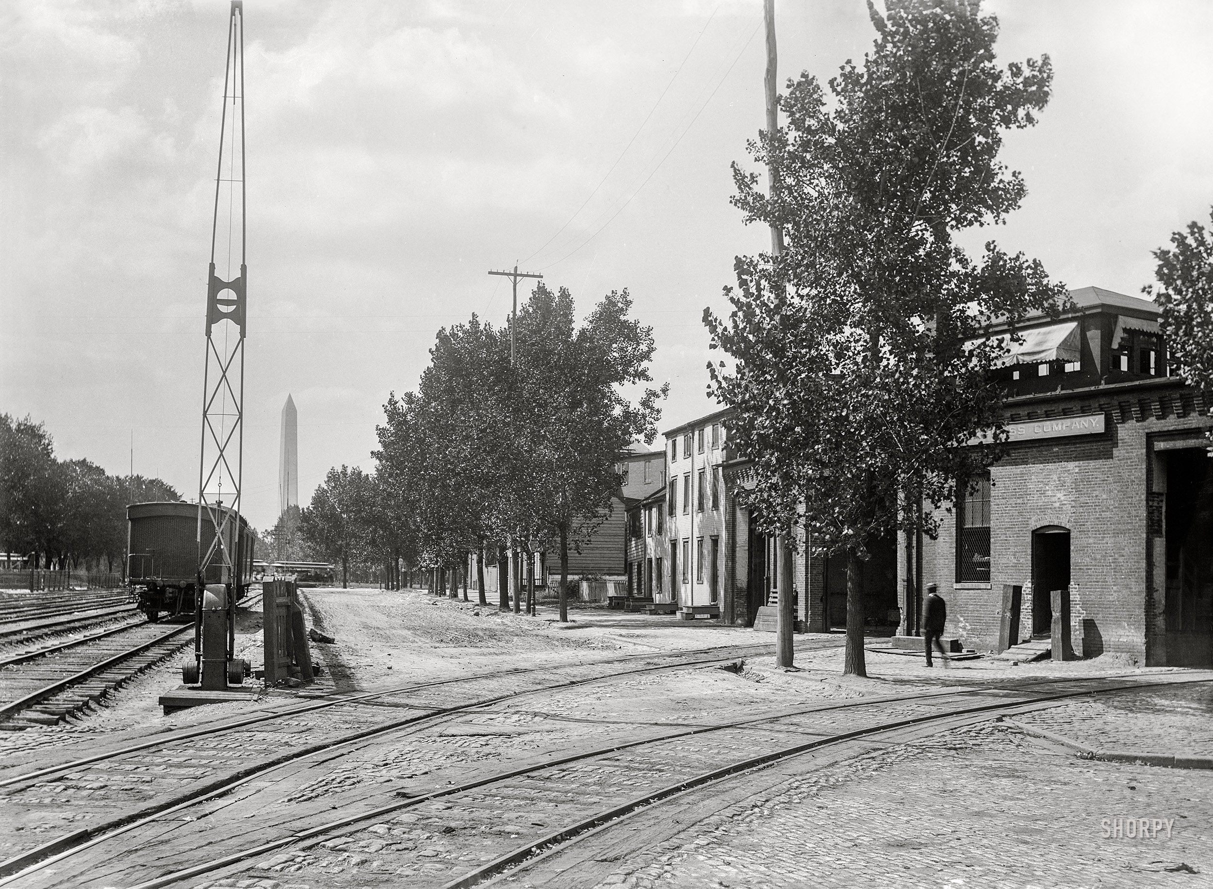 Washington, D.C., circa 1901. "Virginia Avenue at Sixth Street S.W., showing street and railroad tracks in the foreground near the Adams Express Co., and the Washington Monument in the distance." 5x7 inch glass negative, D.C. Street Survey Collection. View full size.