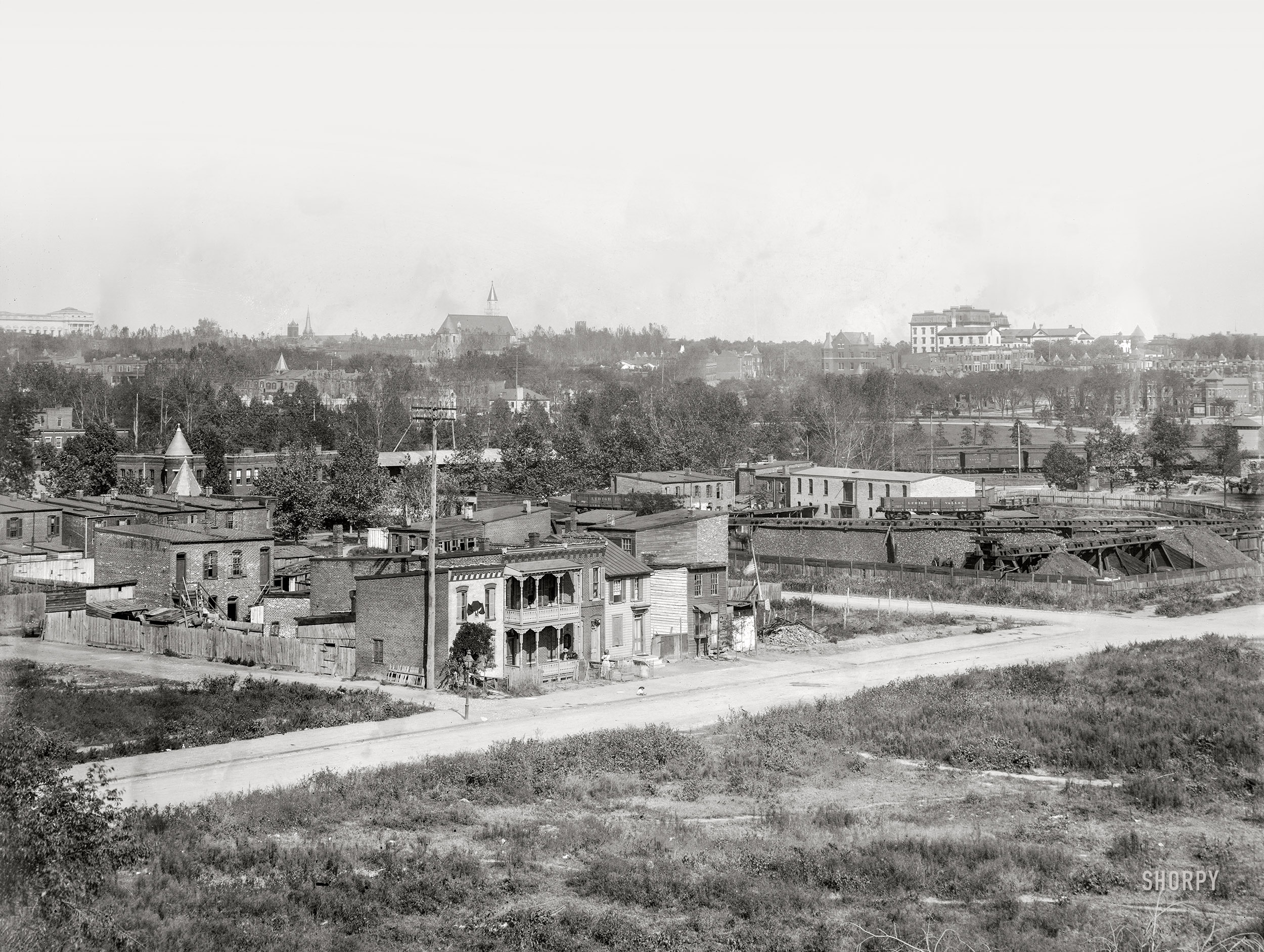Washington, D.C. "View from Randall School of H Street S.W., between Half & First Streets, in 1901 showing coal yard and old homes near railroad station. Houses have McKinley memorials. Portrait of President William McKinley draped in black is visible on the house on the left. A flag is at half mast on the right." Along with at least two other McKinley portraits. 8x10 inch glass negative, D.C. Street Survey Collection. View full size.