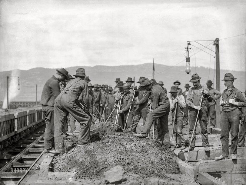 Washington, D.C., or vicinity circa 1901. "Group of laborers on railcar digging through dirt pile along track bed." 6x8 inch glass negative, D.C. Street Survey Collection. View full size.

