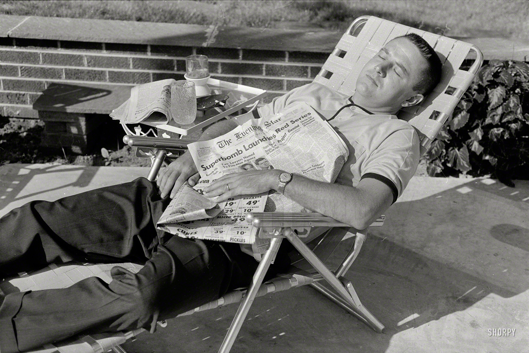 Aug. 8, 1962. Washington, D.C. "Man in lounge chair representing U.S. indiffer&shy;ence" to world affairs at the height of the Cold War. The headline: "Superbomb Launches Red Series -- Siberian Test Believed Near 40 Megatons." Photo by Thomas O'Halloran for U.S. News & World Report. View full size.