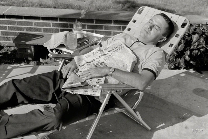 Aug. 8, 1962. Washington, D.C. "Man in lounge chair representing U.S. indiffer&shy;ence" to world affairs at the height of the Cold War. The headline: "Superbomb Launches Red Series -- Siberian Test Believed Near 40 Megatons." Photo by Thomas O'Halloran for U.S. News &amp; World Report. View full size.
