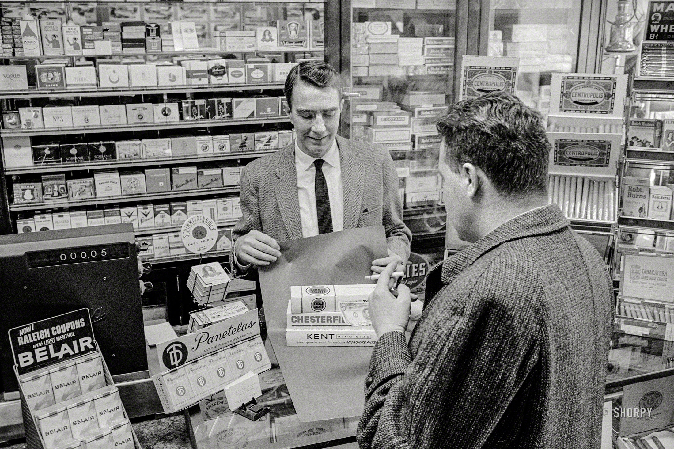 January 15, 1964. "Customer buying cigarettes from tobacconist." 35mm negative by T.J. O'Halloran for U.S. News & World Report. View full size.