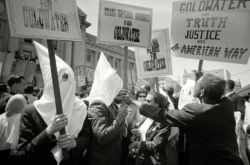 July 12, 1964. "Ku Klux Klan members supporting Barry Goldwater's campaign for the presidential nomination at the Republican National Convention, San Francisco, California, as an African American man pushes signs back." 35mm negative by Warren K. Leffler for U.S. News &amp; World Report. View full size.
