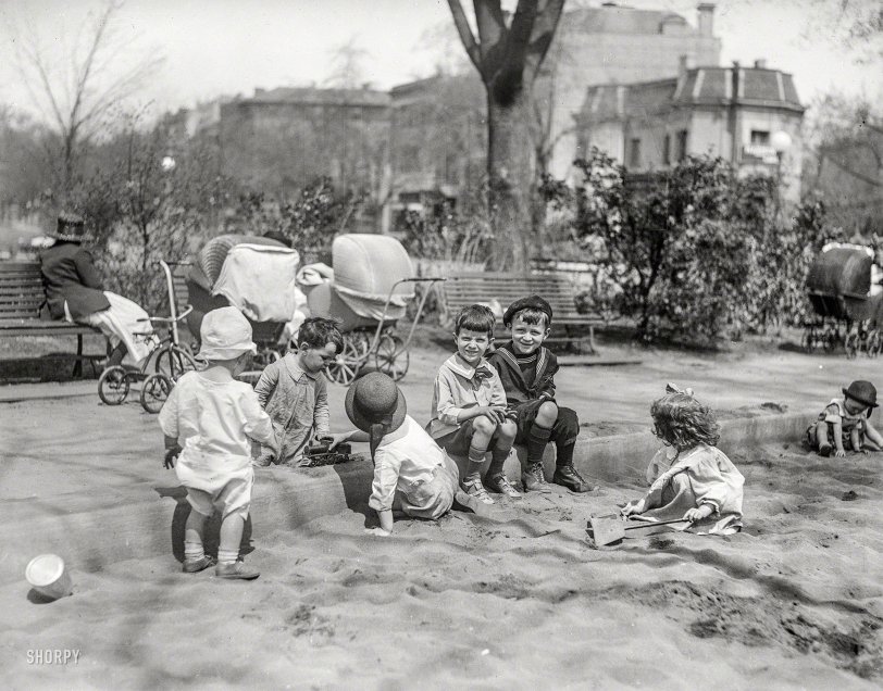 Washington, D.C., 1922. "Children playing in sand." We'd love to stay and chat, but our trike is double-parked. Harris &amp; Ewing glass negative. View full size.

