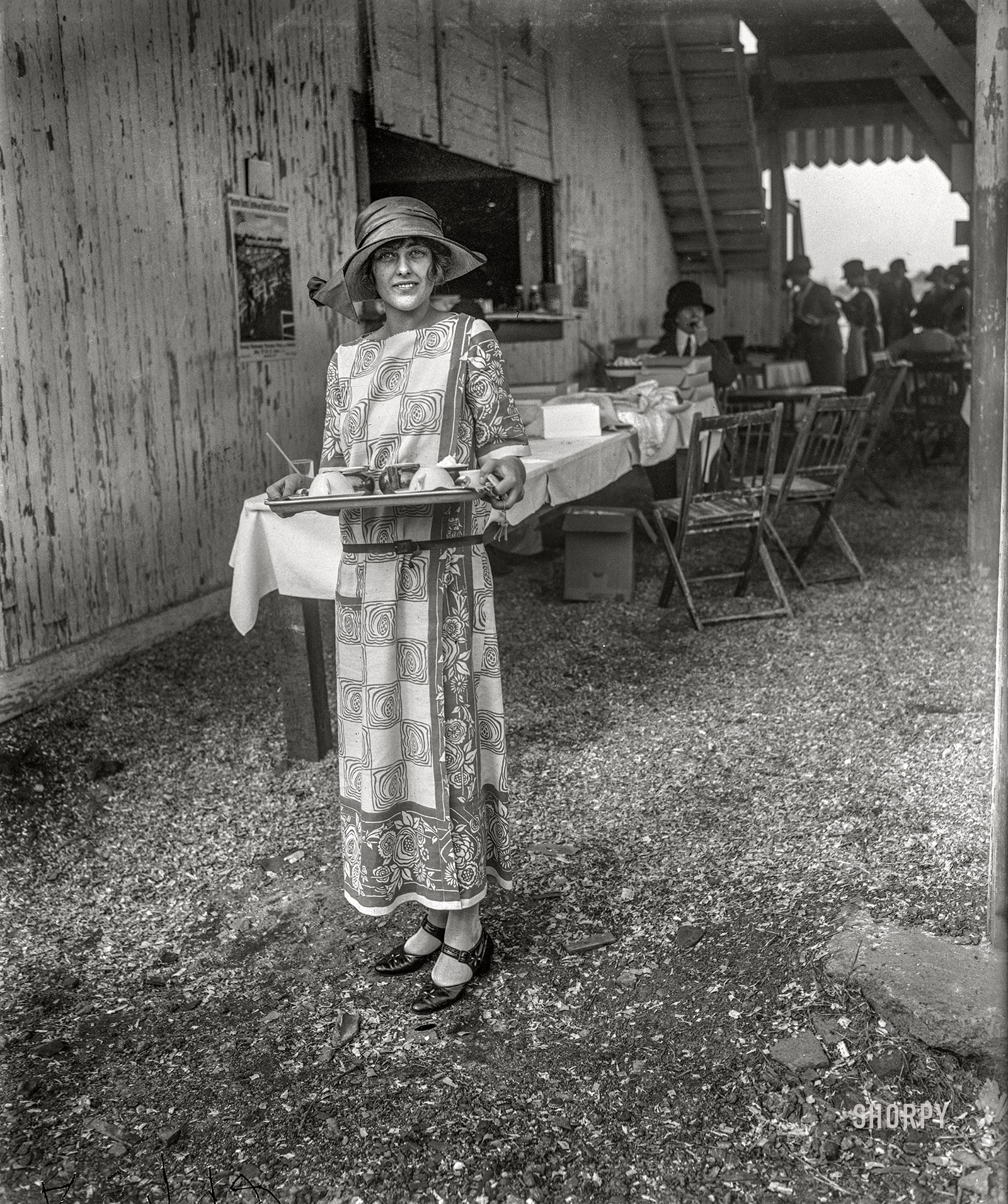 May 16, 1923. "Arlington Park, Virginia. Evelyn Wadsworth, daughter of Senator and Mrs. Wadsworth of New York, serving cold drinks at the National Capital Horse Show." Harris & Ewing Collection glass negative. View full size.