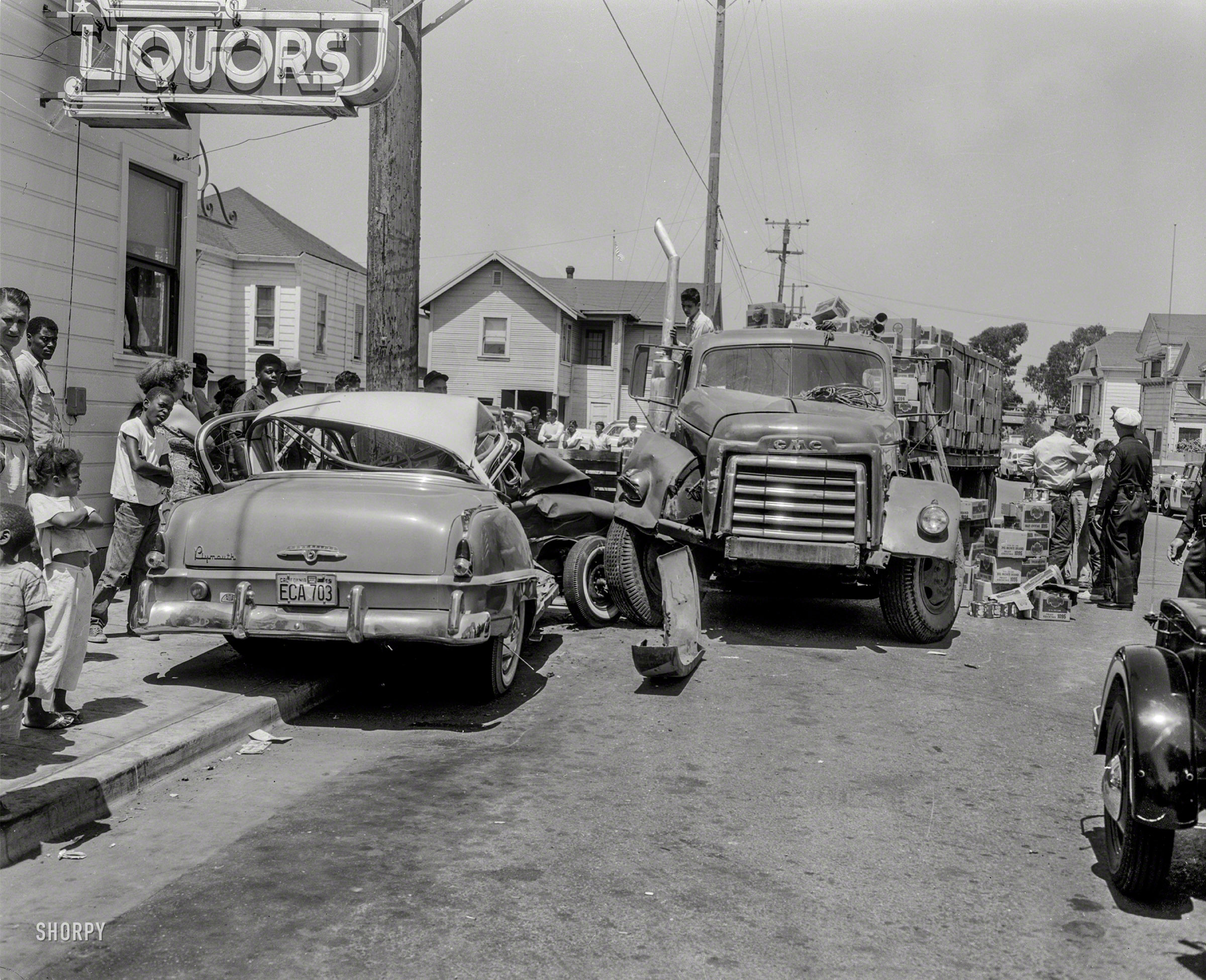 Oakland, Calif., circa 1958. Our third look at the collision between a Plymouth sedan and GMC tractor hauling a load of Del Monte canned fruit. One commenter puts us on Hollis Street in Emeryville. View full size.