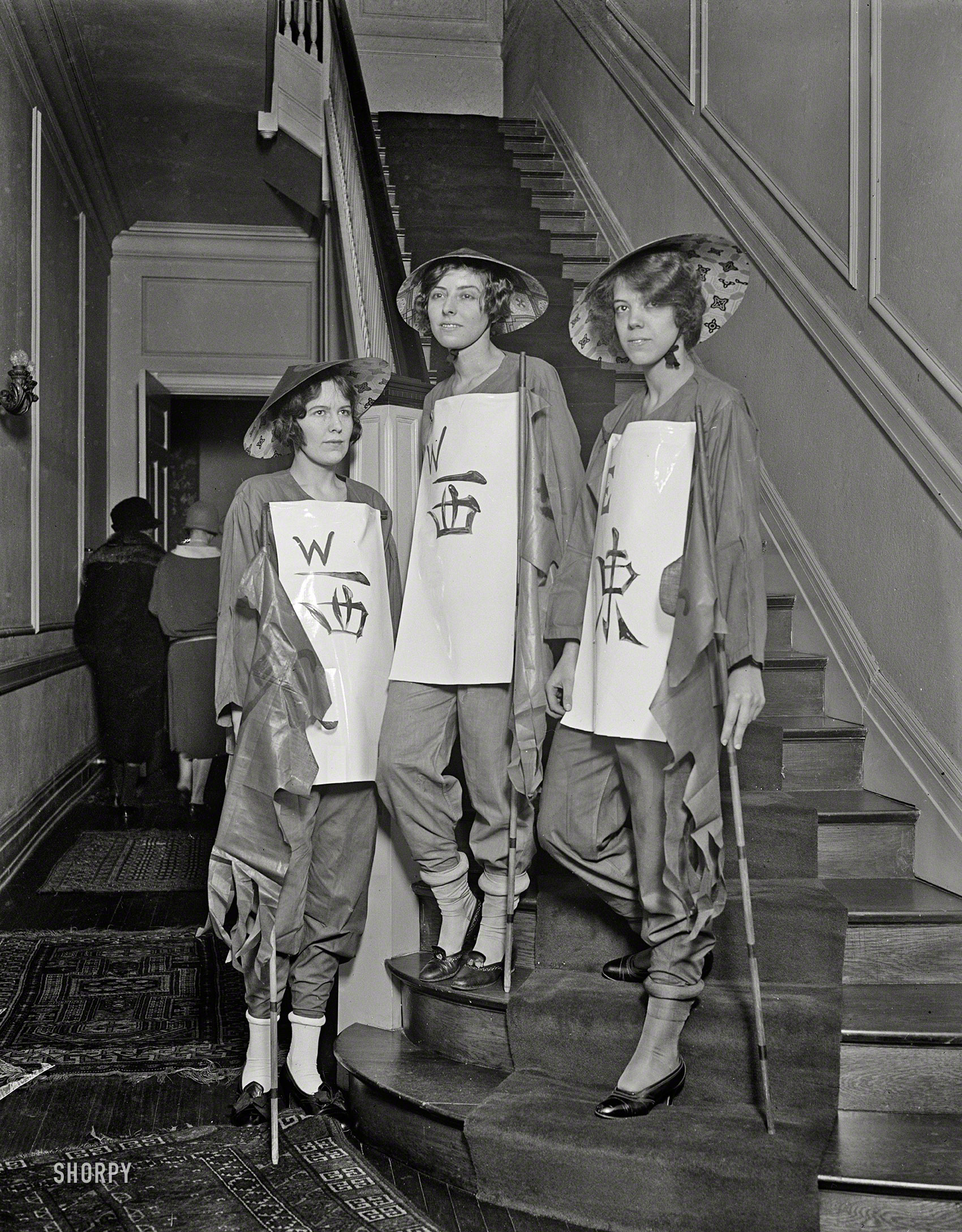 Mah Jong Game Fantasy

Colorful Chinese Legend Enacted
With Society Girls as Human Tiles.

Feb. 6, 1925. "Three Washington society buds in spectacle. The misses Beatrice McLean (left), debutante daughter of Capt. and Mrs. Ridley McLean; Helen Thompson; and Eugenie LeJeune, daughter of General and Mrs. John A. LeJeune; all members of the 'Group of the Winds' who will take part in the human 'Game of Mah Jongg, The Great Dramatic Spectacle,' to be presented for the first time in the Washington Auditorium under the auspices of the Belleau Wood Memorial Association." Harris & Ewing Collection glass negative. View full size.