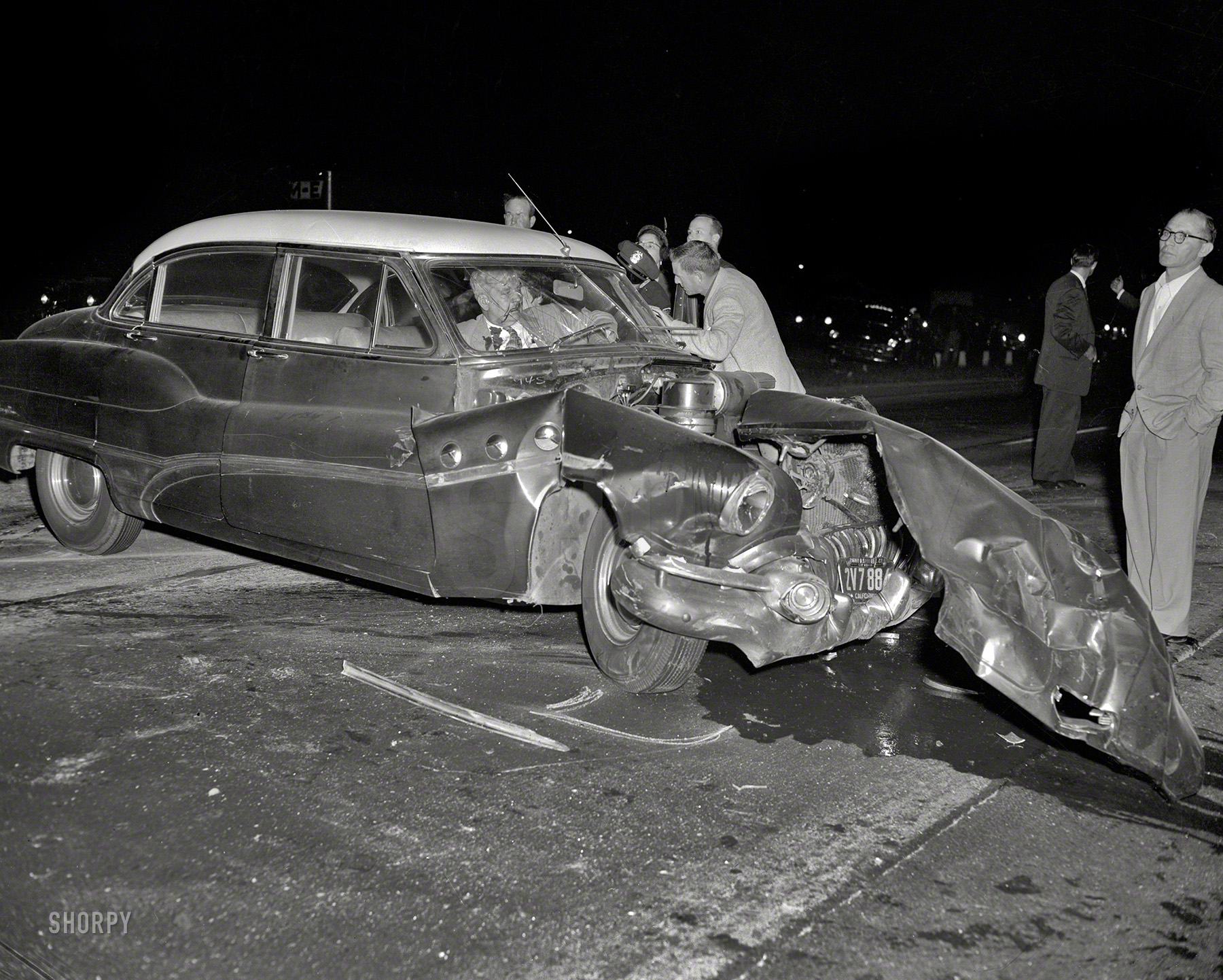 Oakland circa 1955, and yet another Buick come a cropper. We promise to call an ambulance just as soon as you finish filling out these photo releases! 4x5 inch acetate negative from the Shorpy News Photo Archive. View full size.
