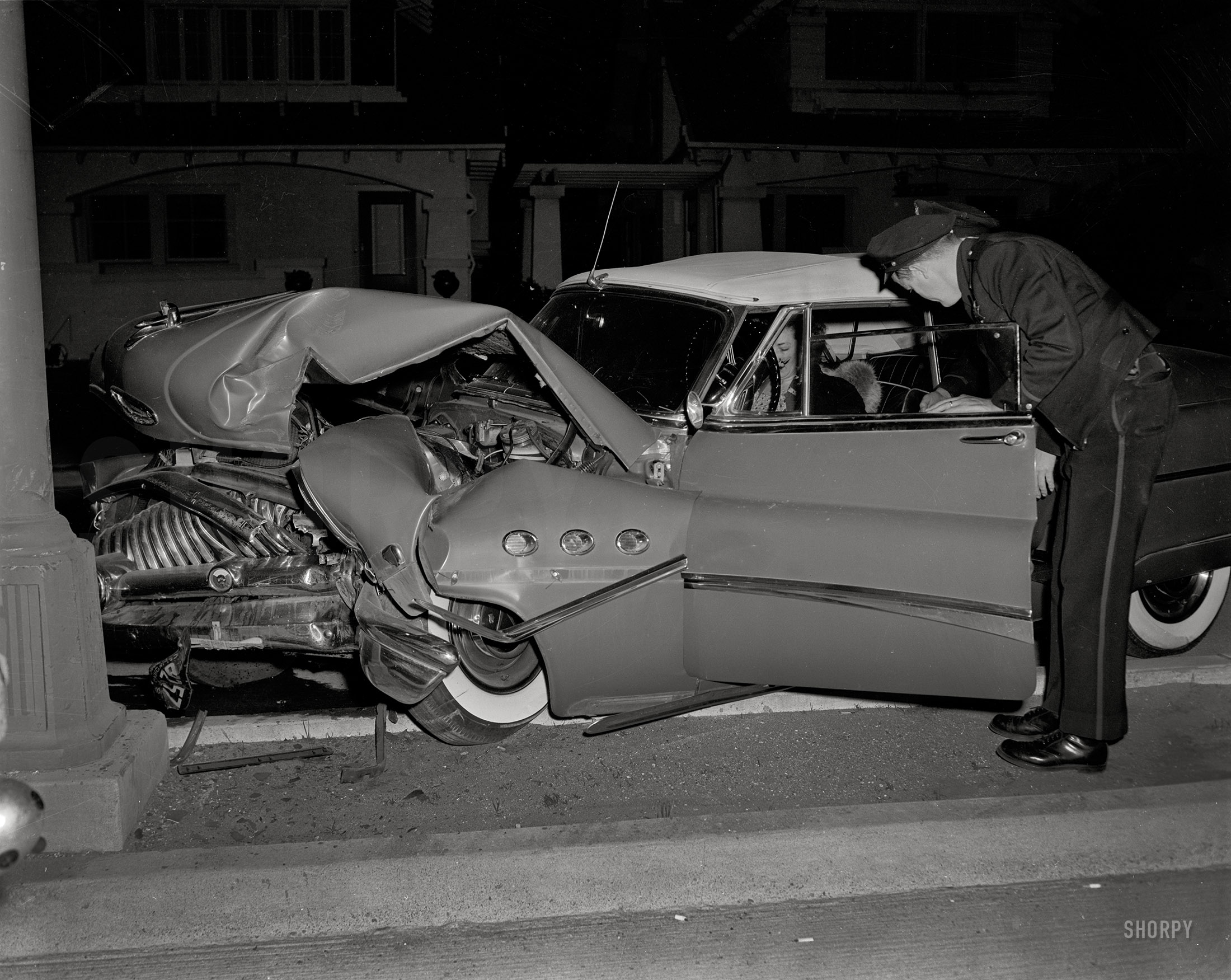 Oakland, California, circa 1955. "Wrecked Buick." A 1953 Super convertible. Long before airbags, there were collapsible steering columns and dished steering wheels. And before that, there was this. 4x5 acetate negative. View full size.