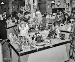 December 1934. "No elephant toys for First Lady. Mrs. Roosevelt, on a Christmas shopping tour, had a hard time convincing Santa Claus that she did not want a toy elephant, a symbol of the Republican Party, as a Christmas present. She is shown here inspecting an assortment of toys at a Washington, D.C., department store Friday." Harris & Ewing Collection glass negative. View full size.